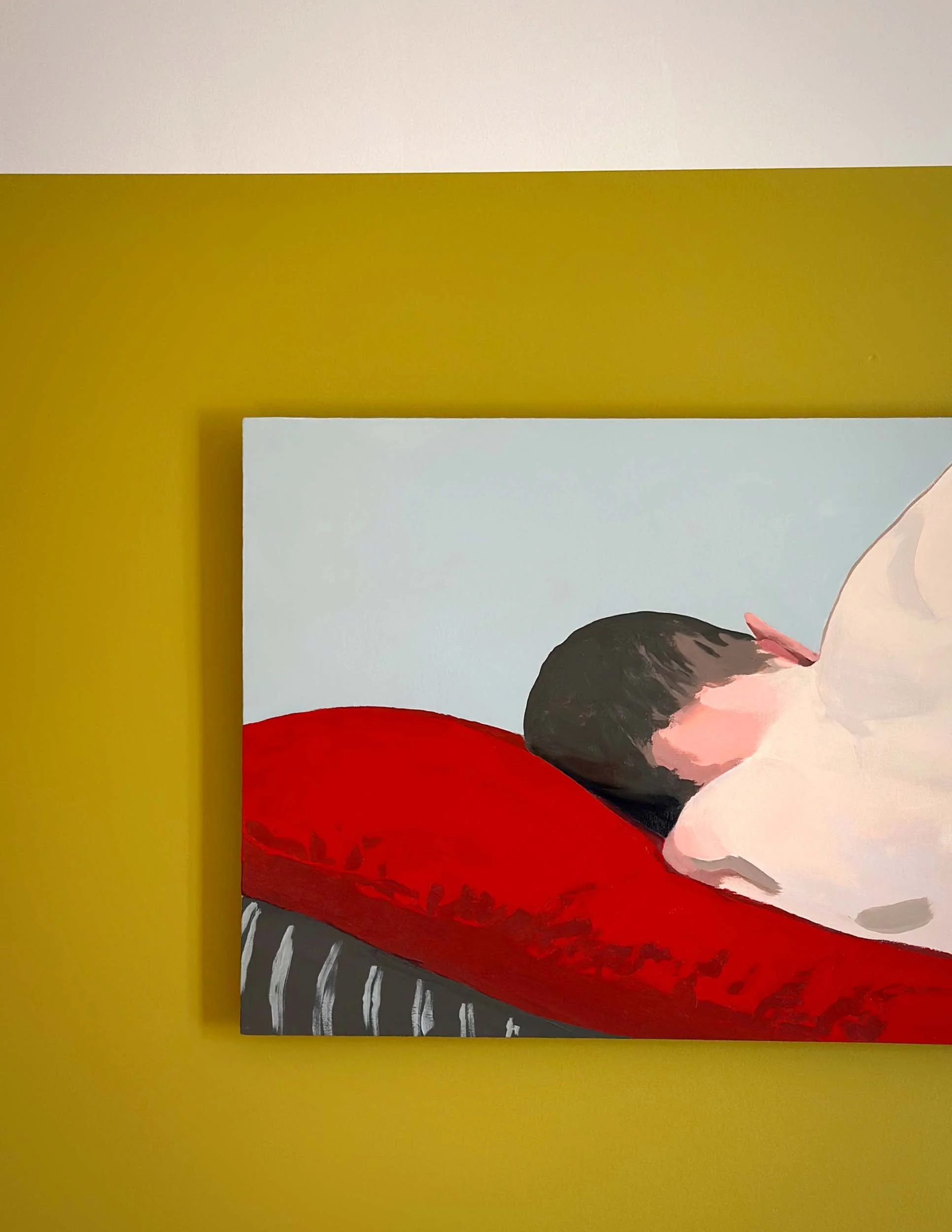 A painting of a person with black hair, wearing a red dress, lying on a bed with a pillow, set against a background with a yellow wall and a white section.