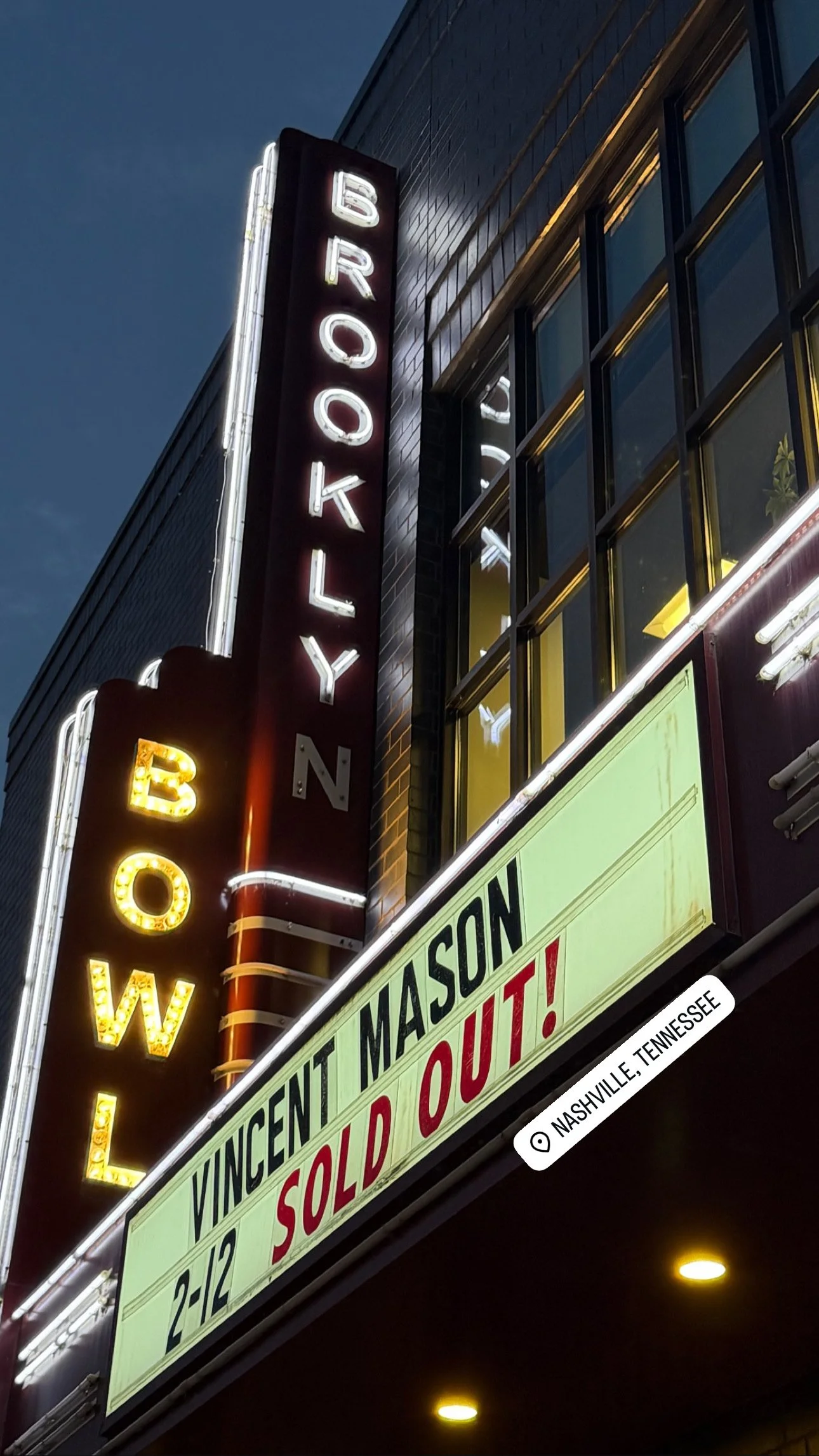 Neon sign reading 'Broadway' and a marquee sign advertising a show or performance in Nashville, Tennessee, with the words 'Vincent Masion' and 'sold out'.