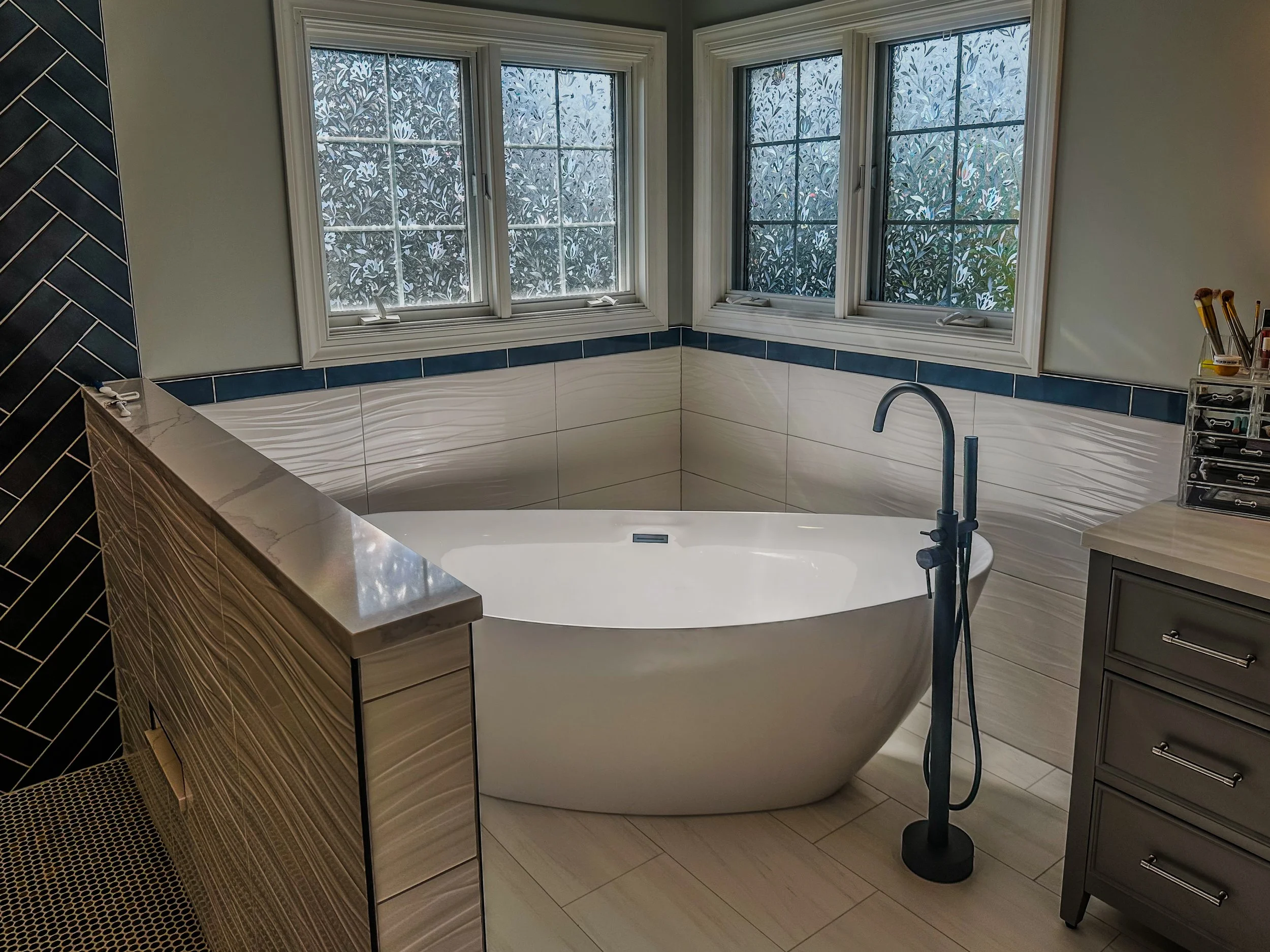 Custom bath remodel freestanding tub white wave tile navy accent border black herringbone Crystal Lake IL