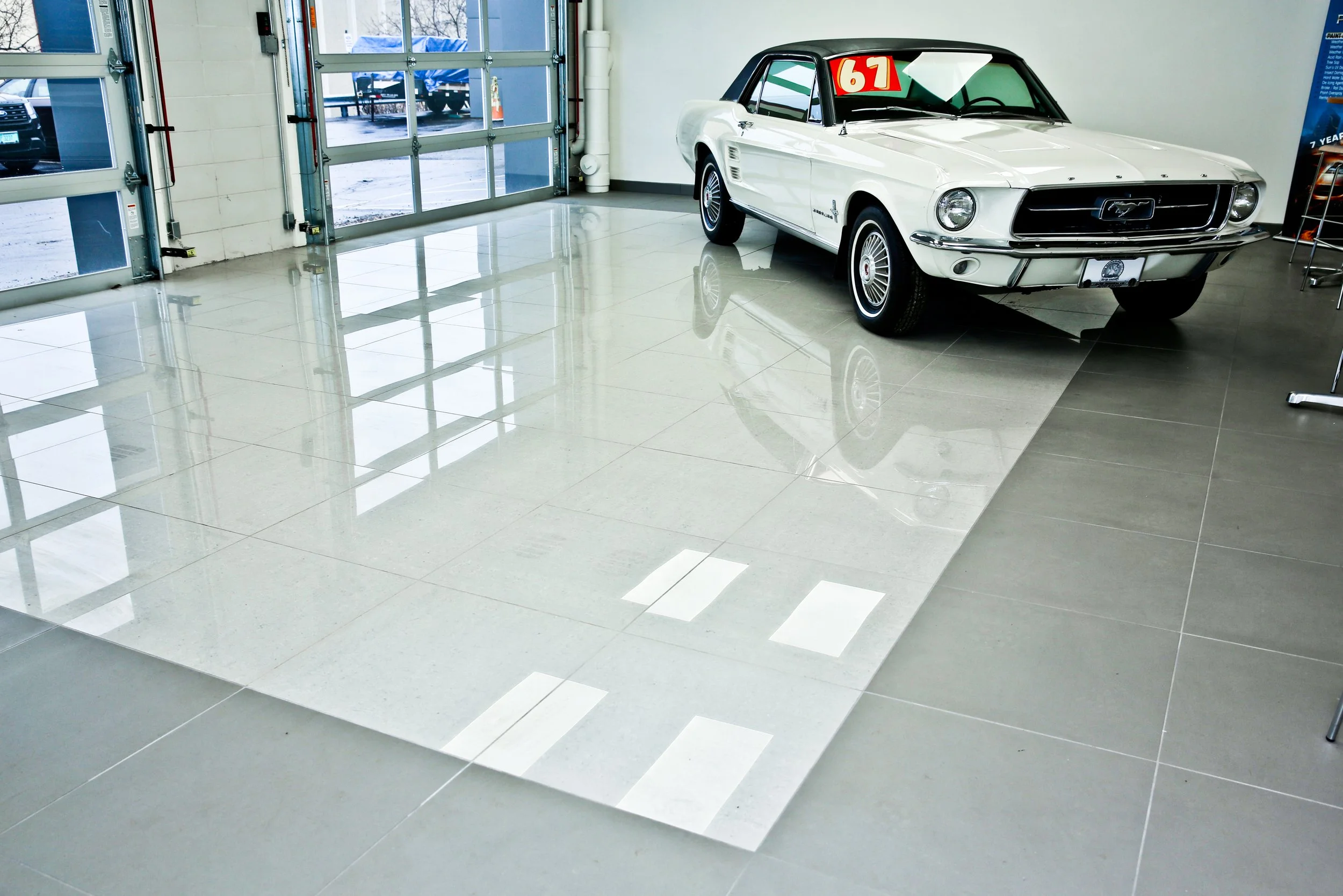 High gloss reflective porcelain tile showroom floor at car dealership in Schaumburg IL