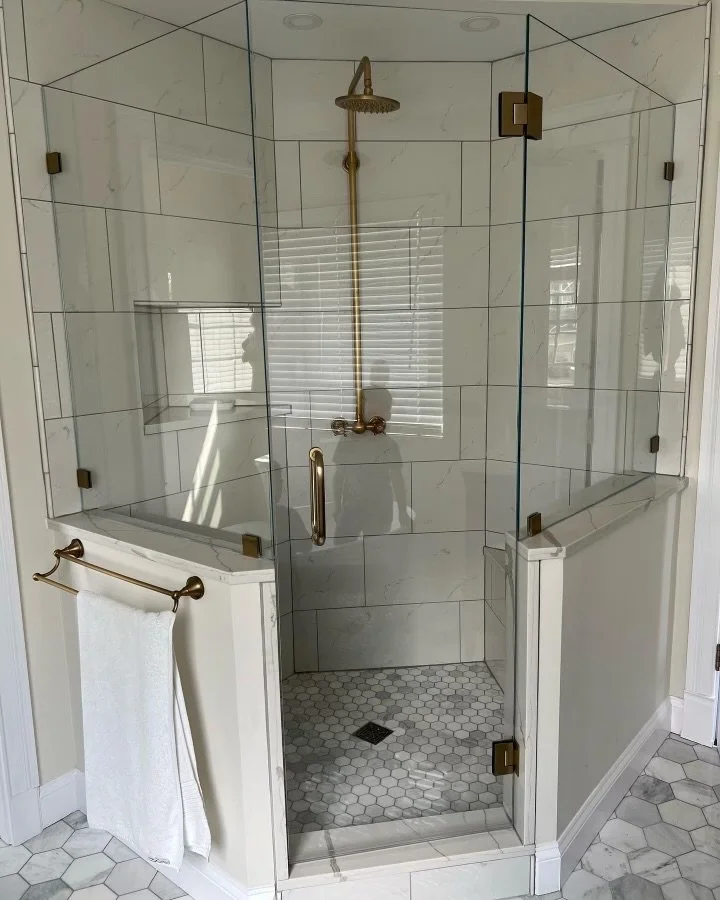 Neo angle frameless glass shower large format marble tile hex floor brass fixtures in Woodstock IL