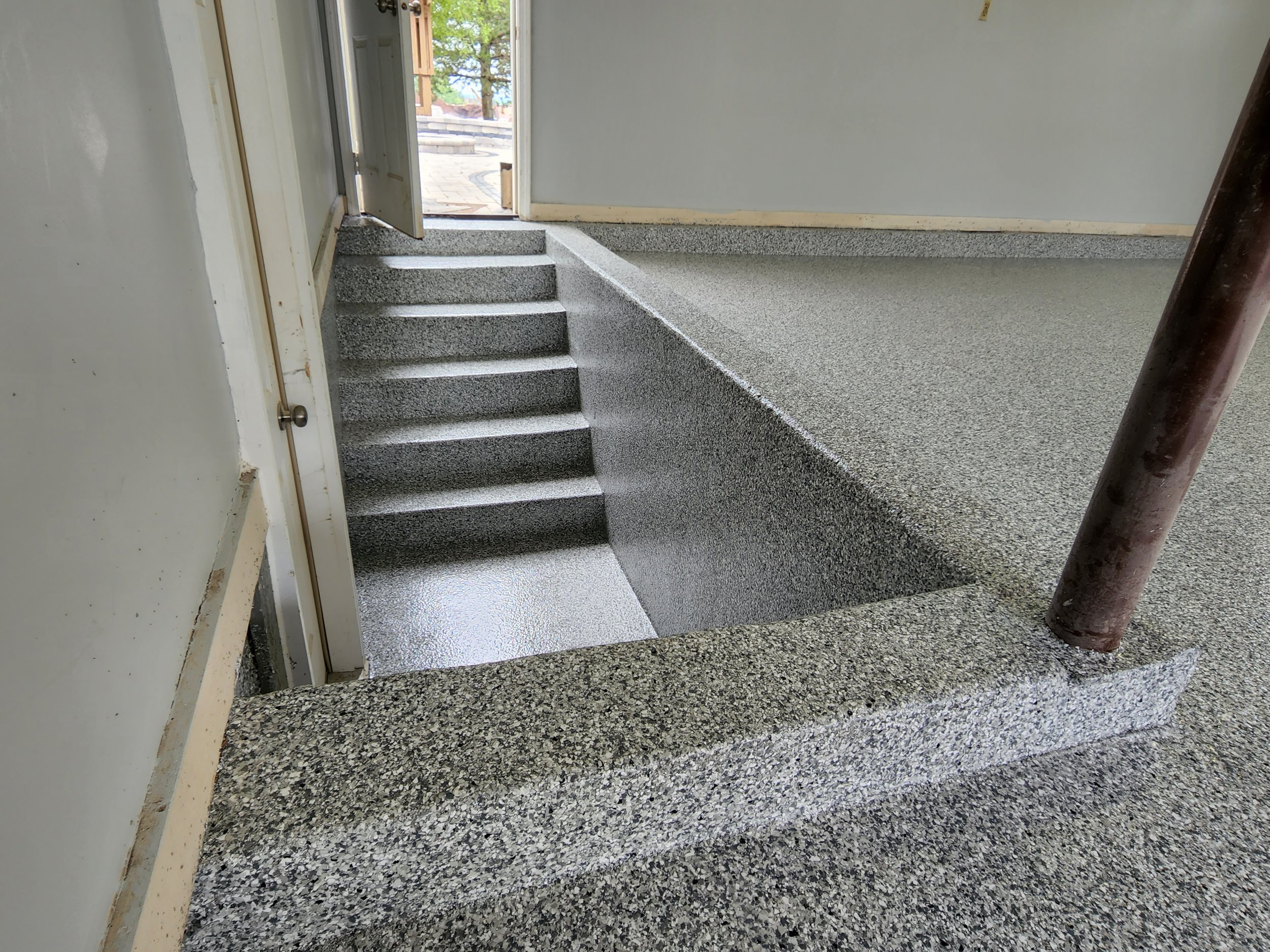 Custom epoxy floor coatings by Artisan Tile Creations serving Crystal Lake IL and the northwest Chicago suburbs. Specializing in metallic epoxy basement floors, epoxy flake garage floors, and decorative epoxy coatings in copper, bronze, orange, brown