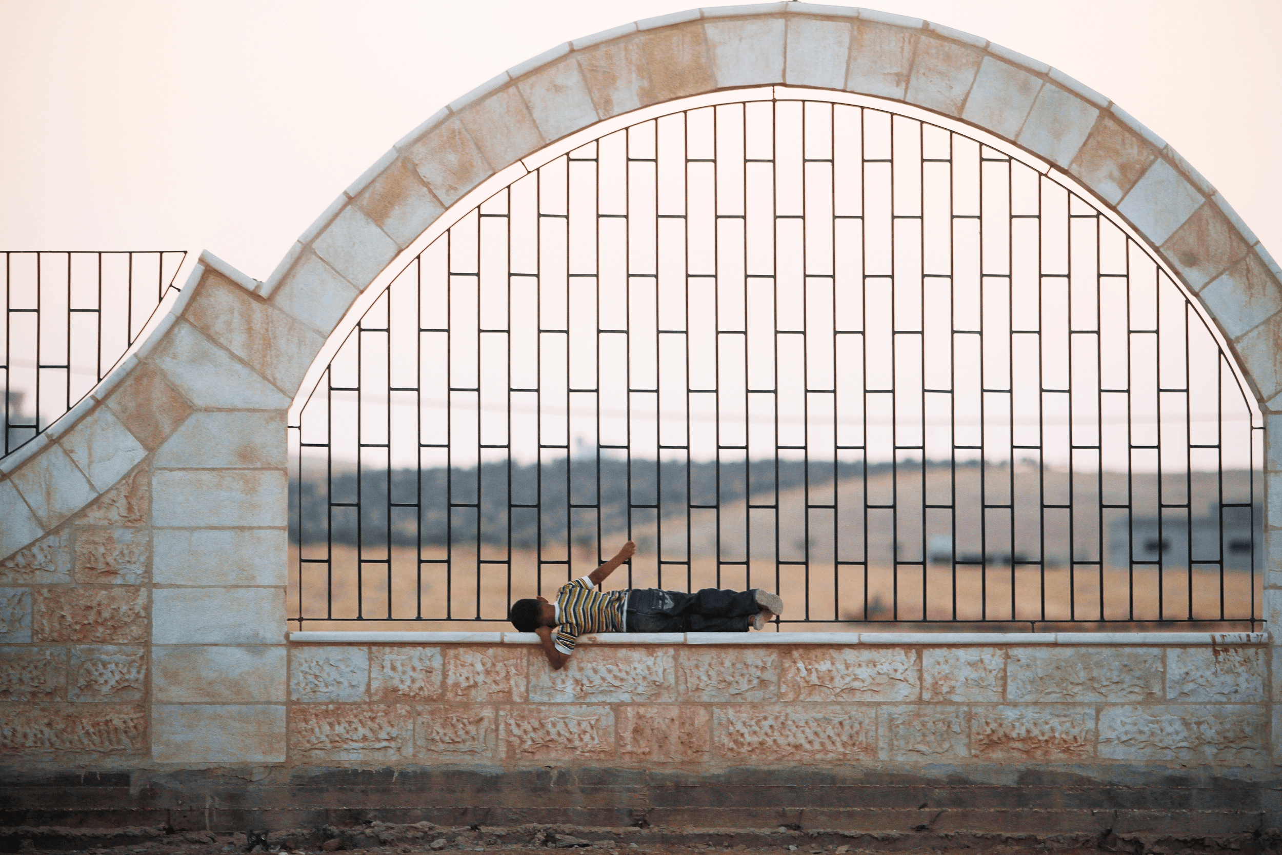  A Syrian boy plays on a fence at the refugee camp at the King Abdullah Gardens inside the town of Ramtha, Sunday, July 22, 2012. (Photo Credit/Tara Todras-Whitehill). 