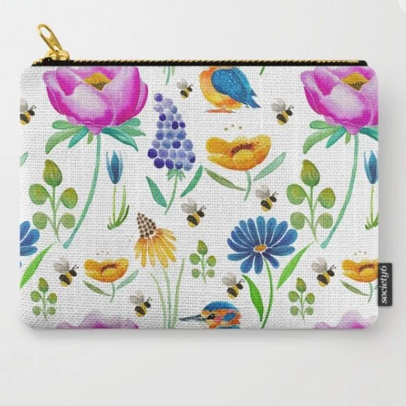 A fabric pouch with a zippered top featuring a colorful floral and bird pattern, including pink flowers, blue and orange birds, purple grapes, yellow flowers, green leaves, and small bees on a white background.