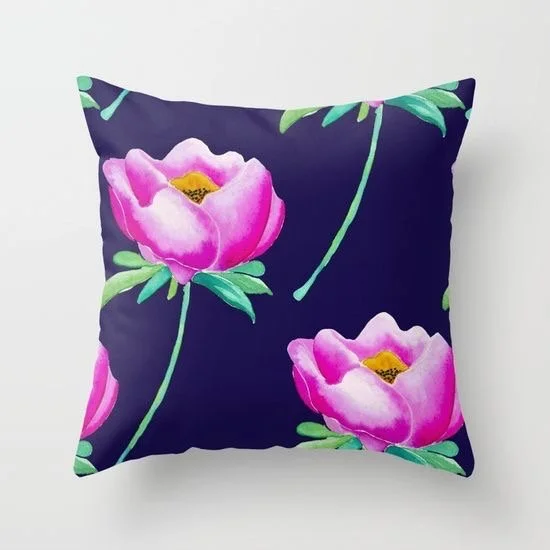 Square pillow with a dark background and pink floral pattern featuring large pink flowers with green stems and leaves.