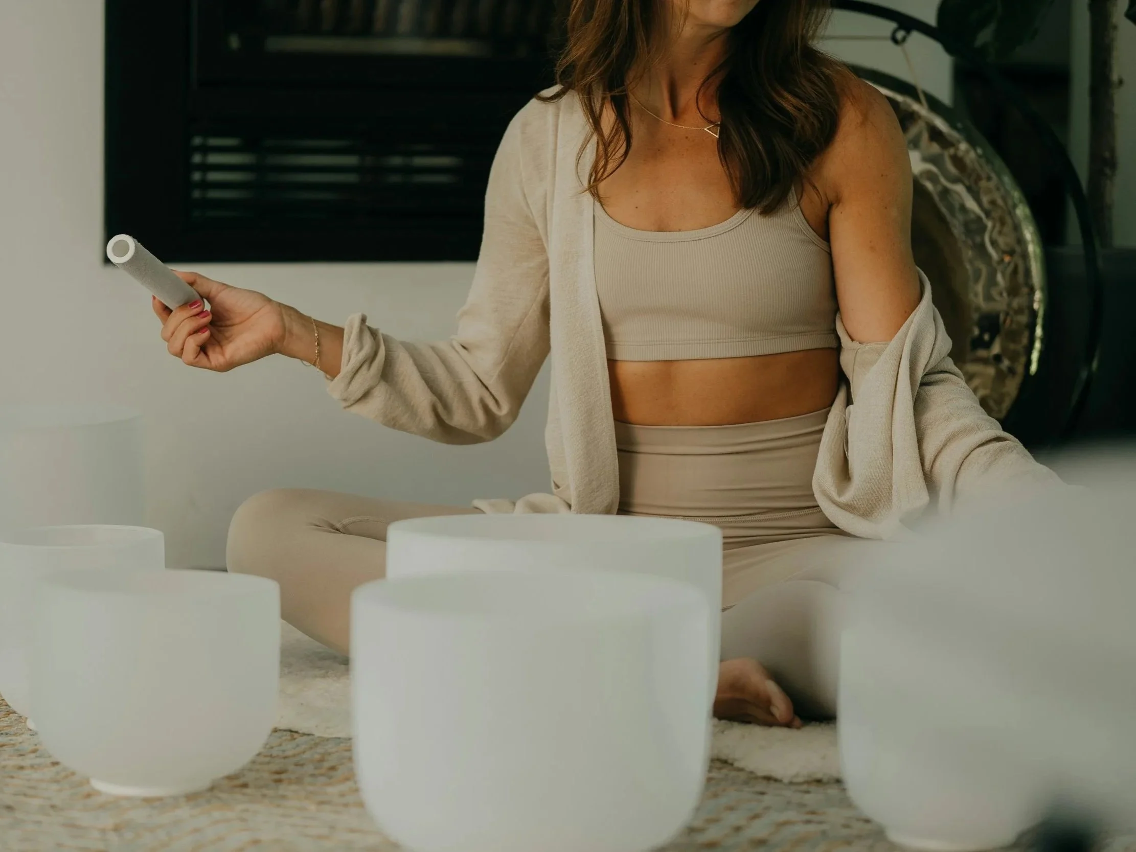 Facilitator leading a sound healing meditation during a guided psilocybin retreat.