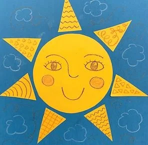 Children's drawing of a smiling sun with a face, surrounded by blue sky and clouds