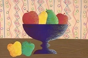 Colorful jelly beans in a dark blue bowl on a wooden surface with a patterned background