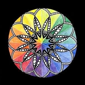 Colorful mandala design with intricate black and white patterns and a rainbow gradient background.
