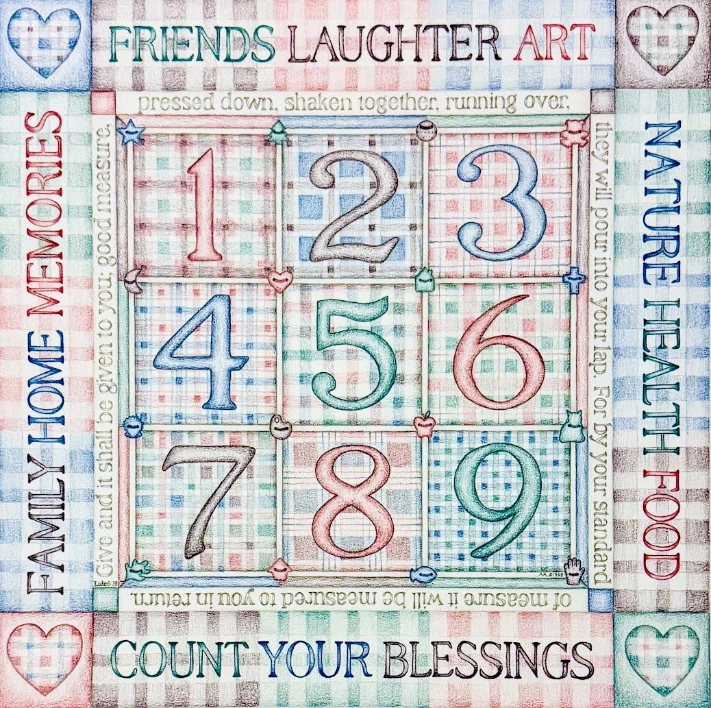 Colorful embroidered fabric with a tic-tac-toe style grid featuring numbers 1 through 9 in each square. Surrounding text includes phrases like 'Friends Laughter Art,' 'Family Home Memories,' 'Nature Health', and 'Count Your Blessings.' Decorative hea