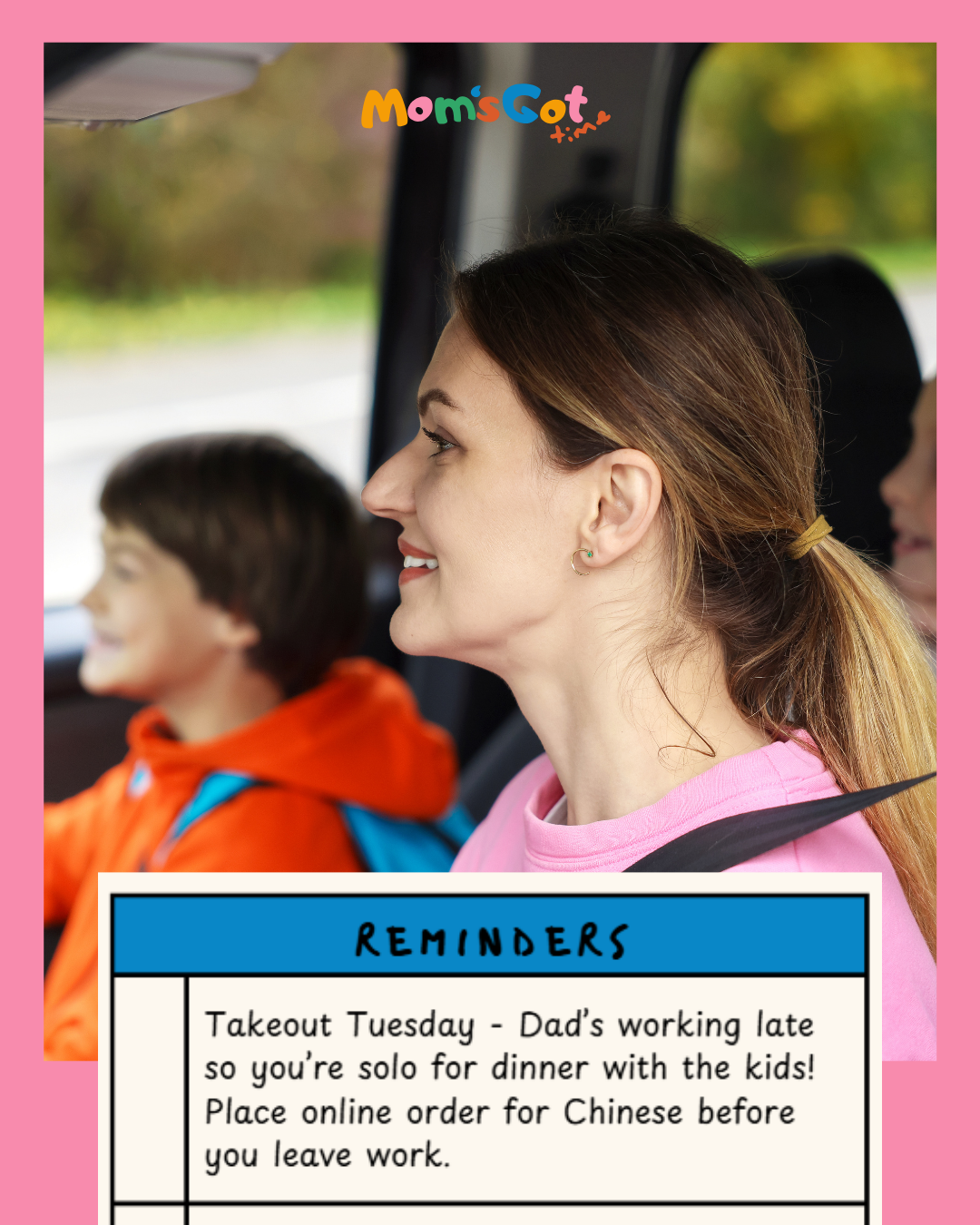 A woman with brown hair tied back in a ponytail, smiling and wearing a pink shirt, sitting in a car with two children, one wearing an orange hoodie, all in a vehicle with a blurred outdoor background.
