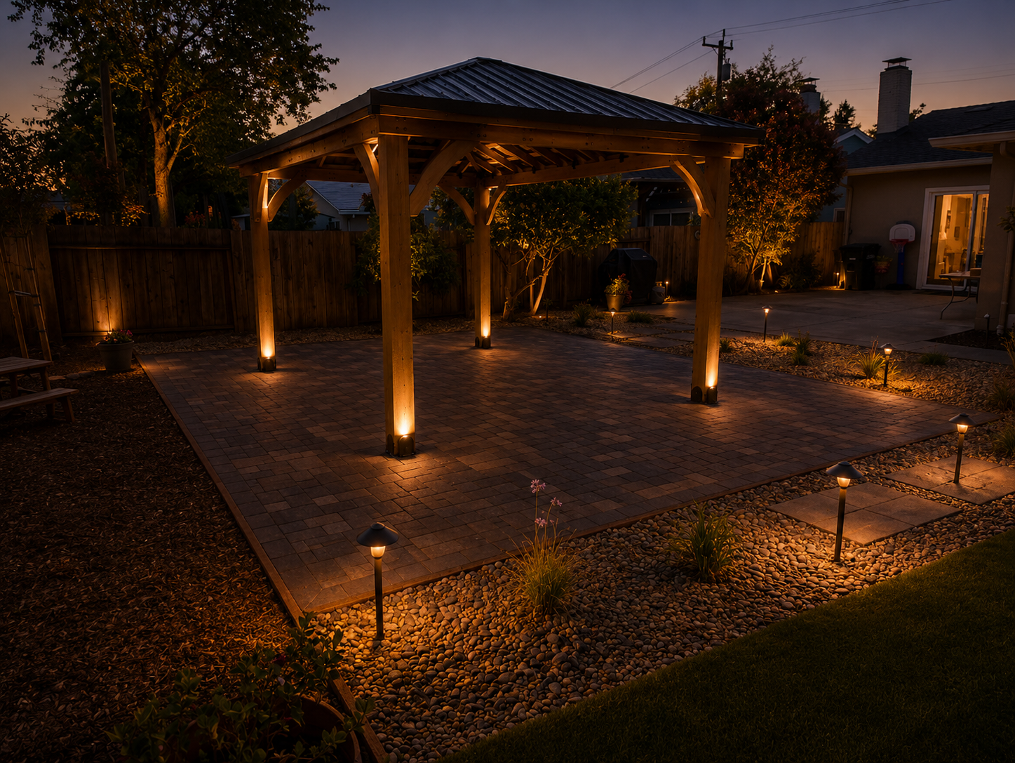 A backyard patio with a wooden pergola, landscape lighting, and potted plants during dusk.