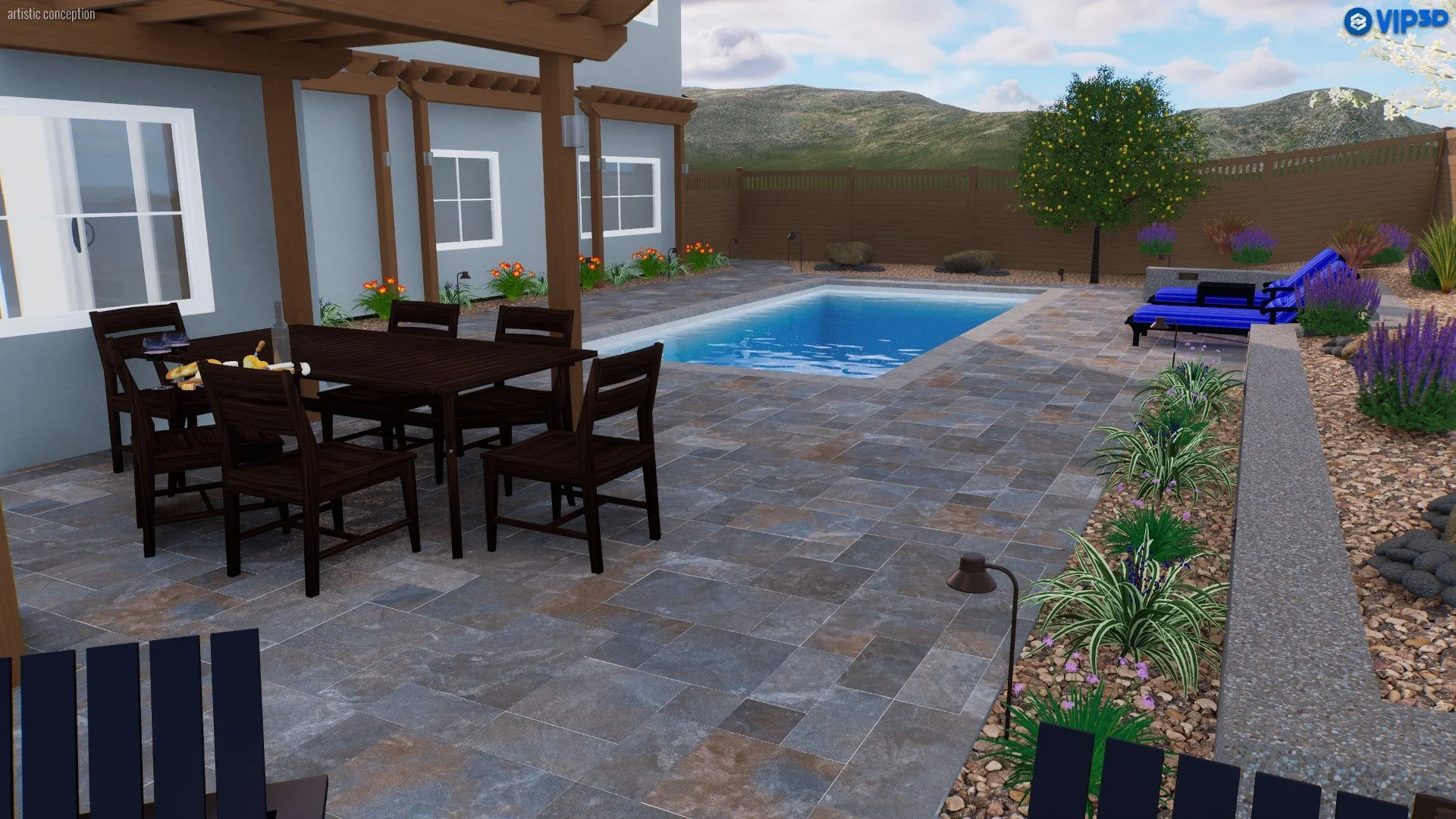 A backyard patio with a blue swimming pool, wooden outdoor dining table, and chairs, surrounded by colorful plants, flowers, and a privacy fence, with mountains in the background.