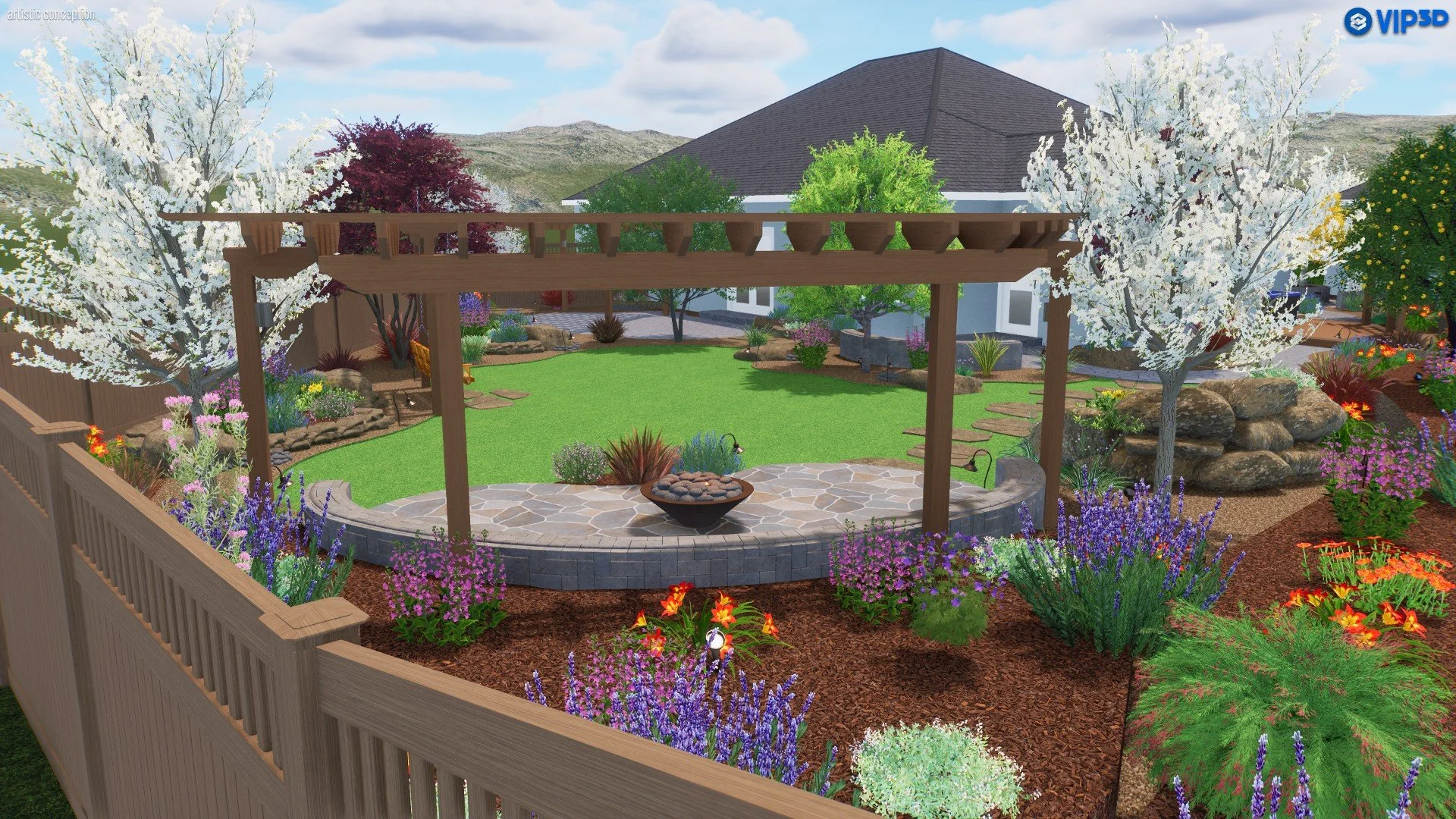 A landscaped backyard garden with a wooden pergola, lush green lawn, colorful flowers, trees with white blossoms, and a stone patio with a fire pit, enclosed by a wooden fence, with a house and mountains in the background.