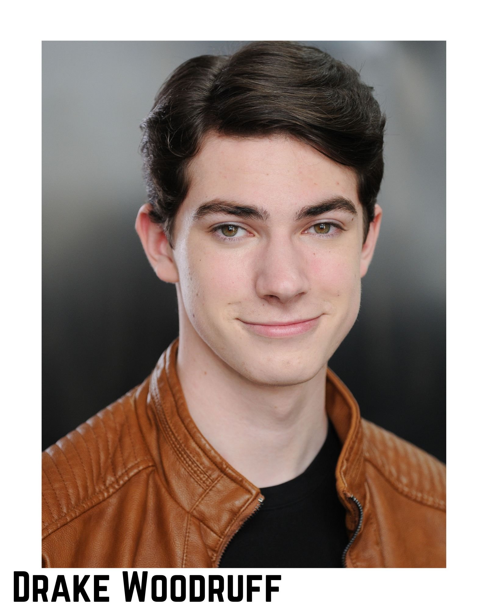 Close-up of a young man with short dark hair, fair skin, and wearing a brown leather jacket, smiling slightly, with text at the bottom reading "Drake Woodruff."