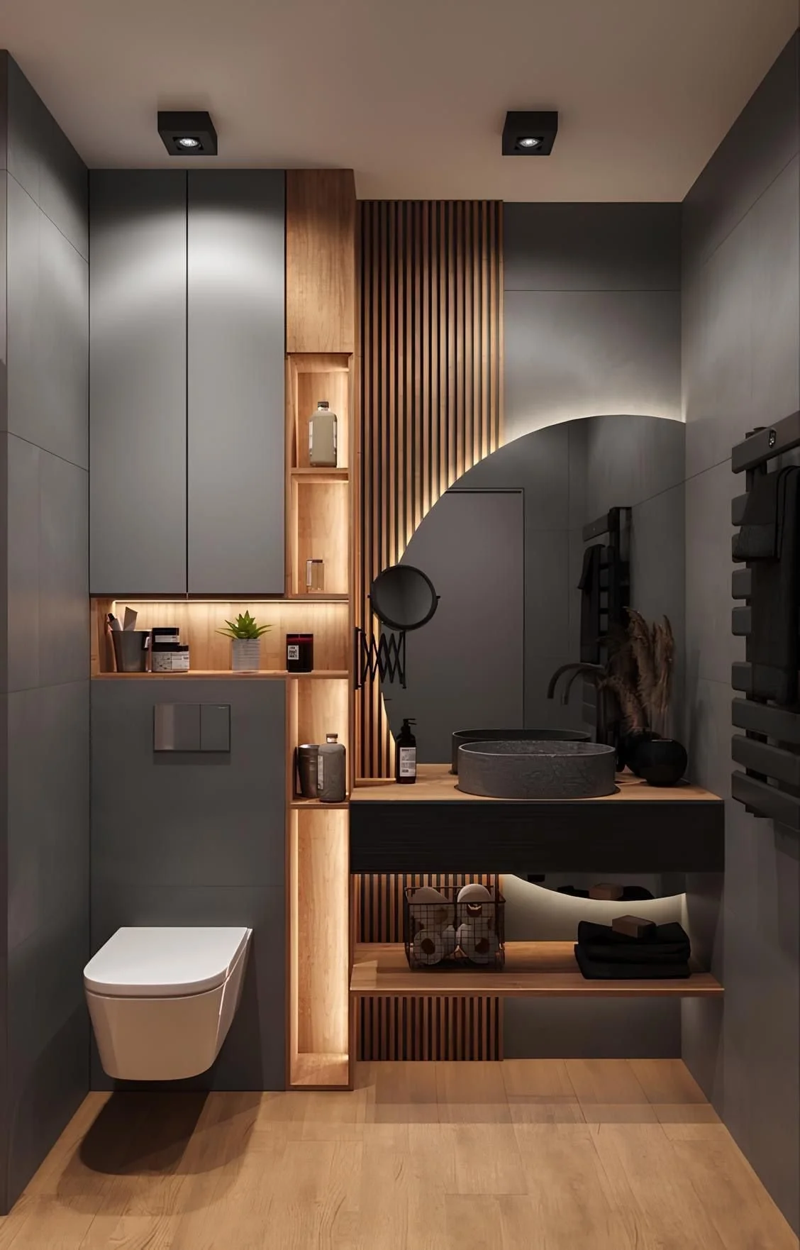 Modern bathroom with gray walls, wooden cabinetry, and unique lighting. Features include a wall-mounted toilet, a stone sink, a mirror, decorative items, and folded towels.