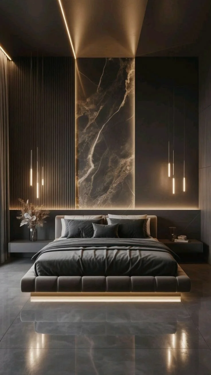 Modern bedroom with dark walls, black bed with black bedding and pillows, minimalistic floating nightstands, pendant lights, a marble accent wall, and a polished tile floor reflecting the lighting.