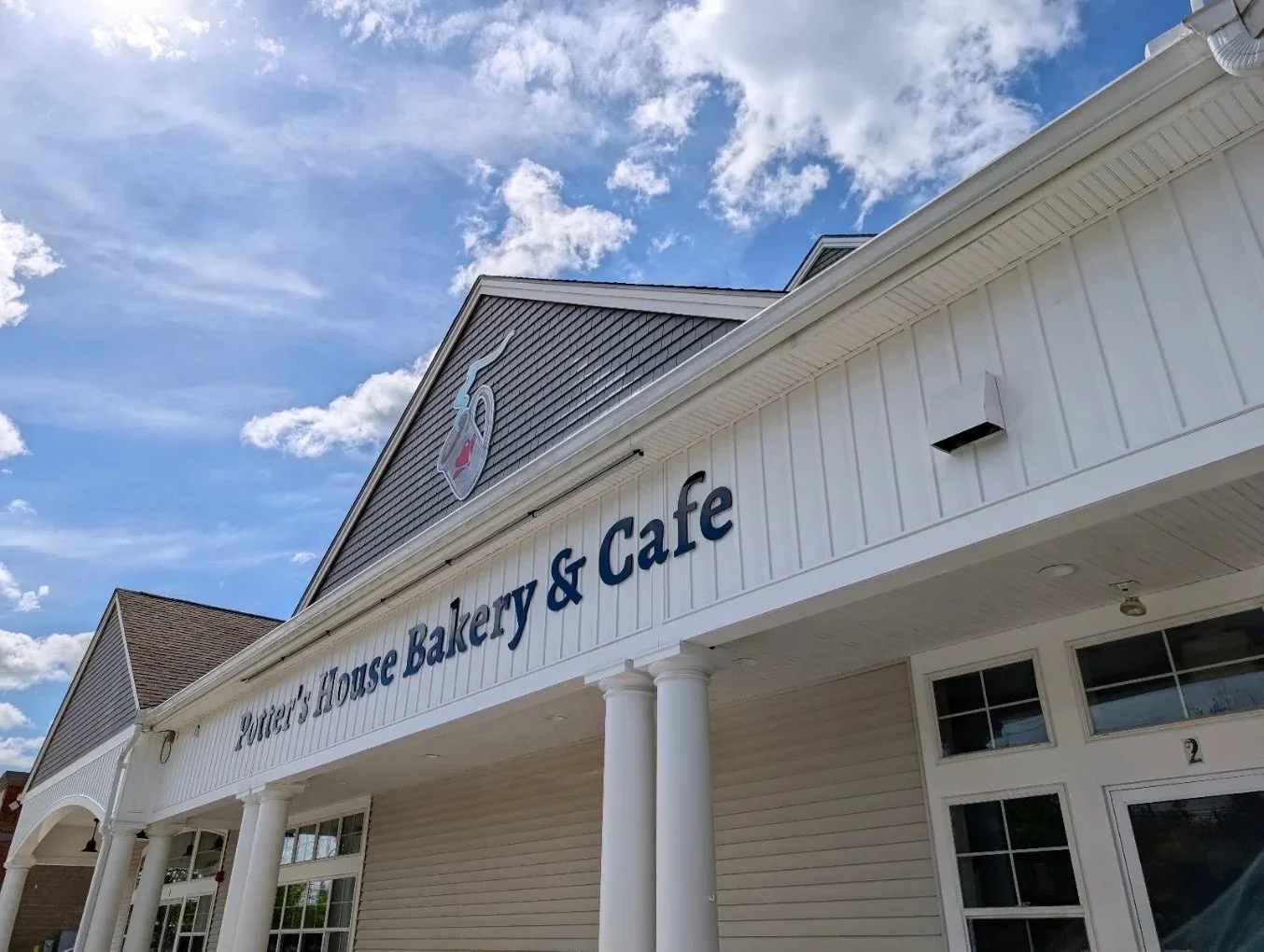 Exterior view of Yorick's House Bakery & Cafe building under a partly cloudy sky.