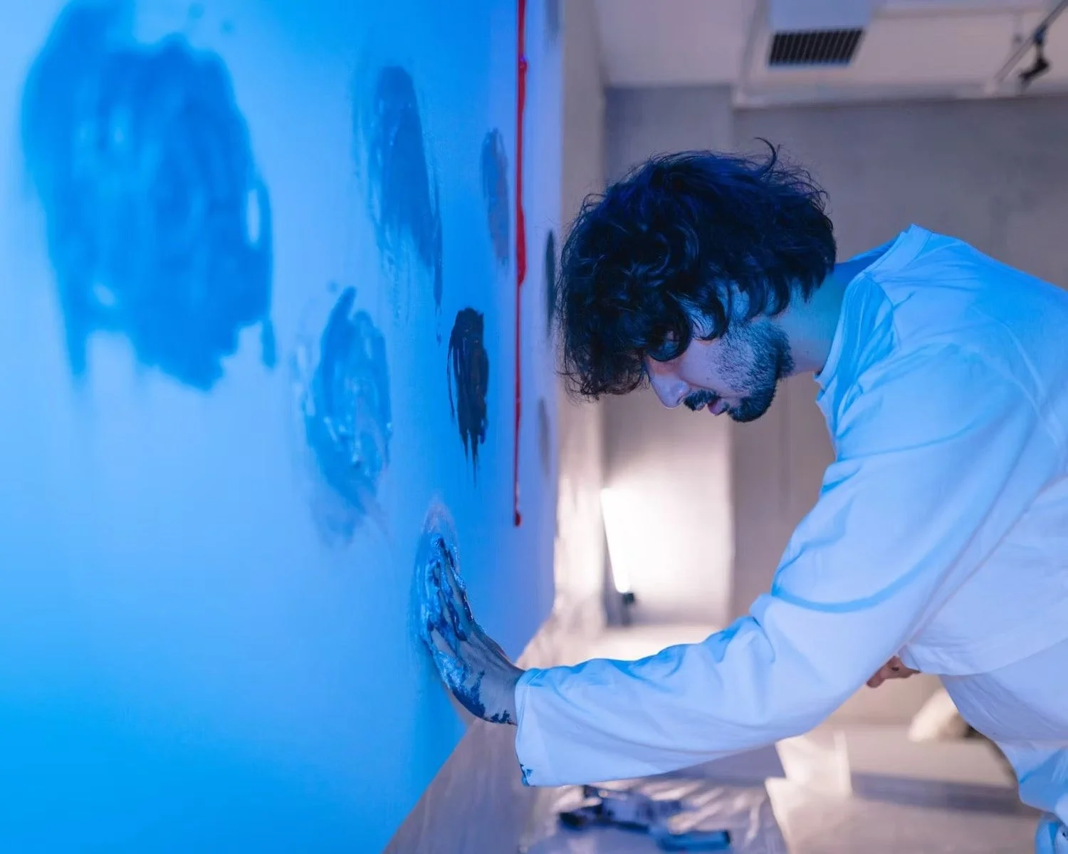 Artist Touching Painted Wall
