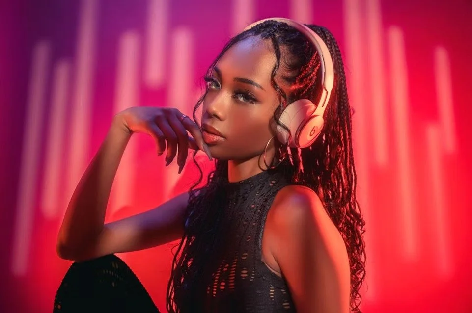 A woman wearing sleek headphones poses against a neon red and pink-lit background. Her confident expression and stylish outfit evoke a futuristic DJ aesthetic.