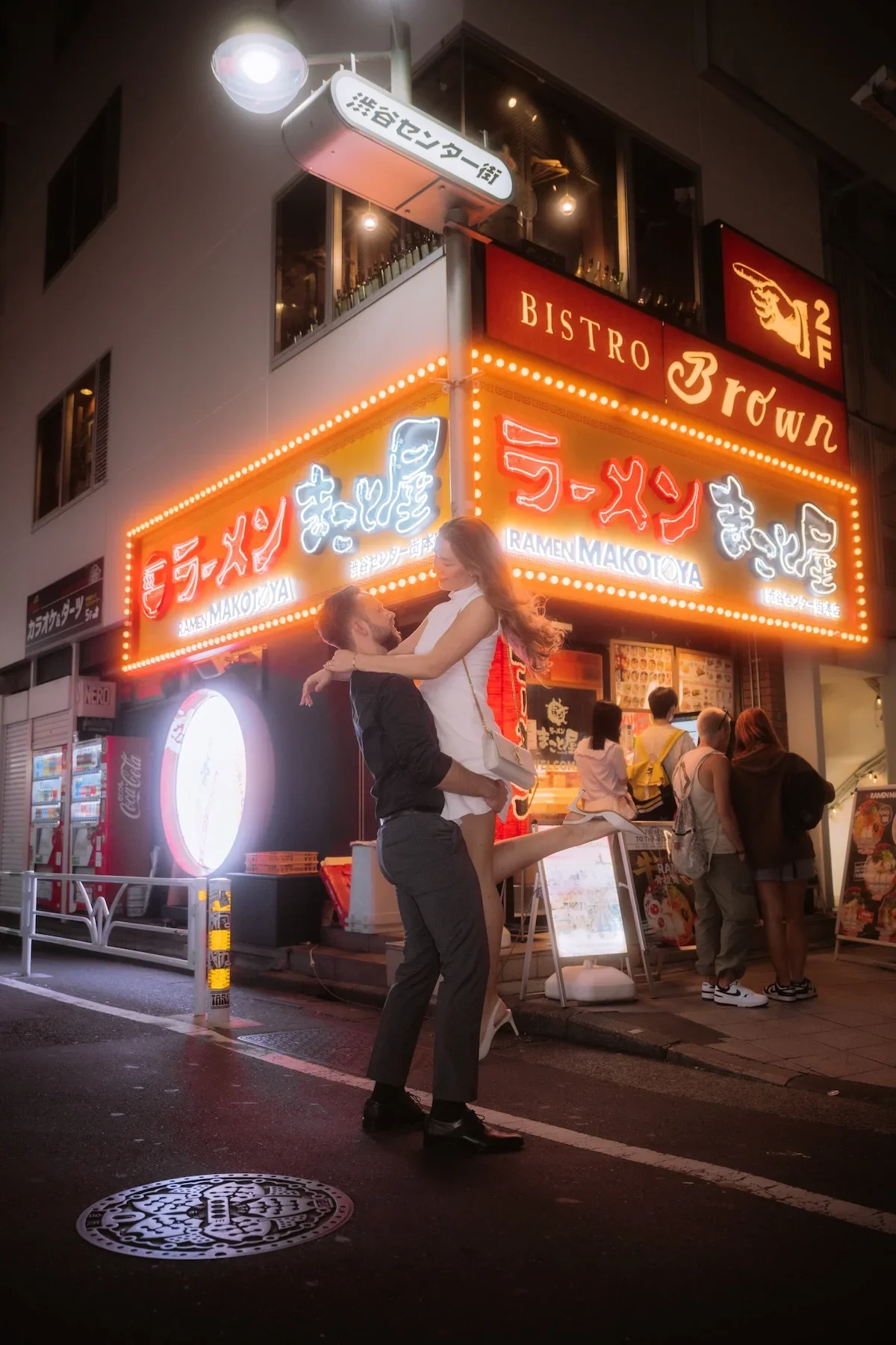  Romantic couples portrait featuring creative motion blur and vibrant neon side streets in Shibuya Tokyo at night. 