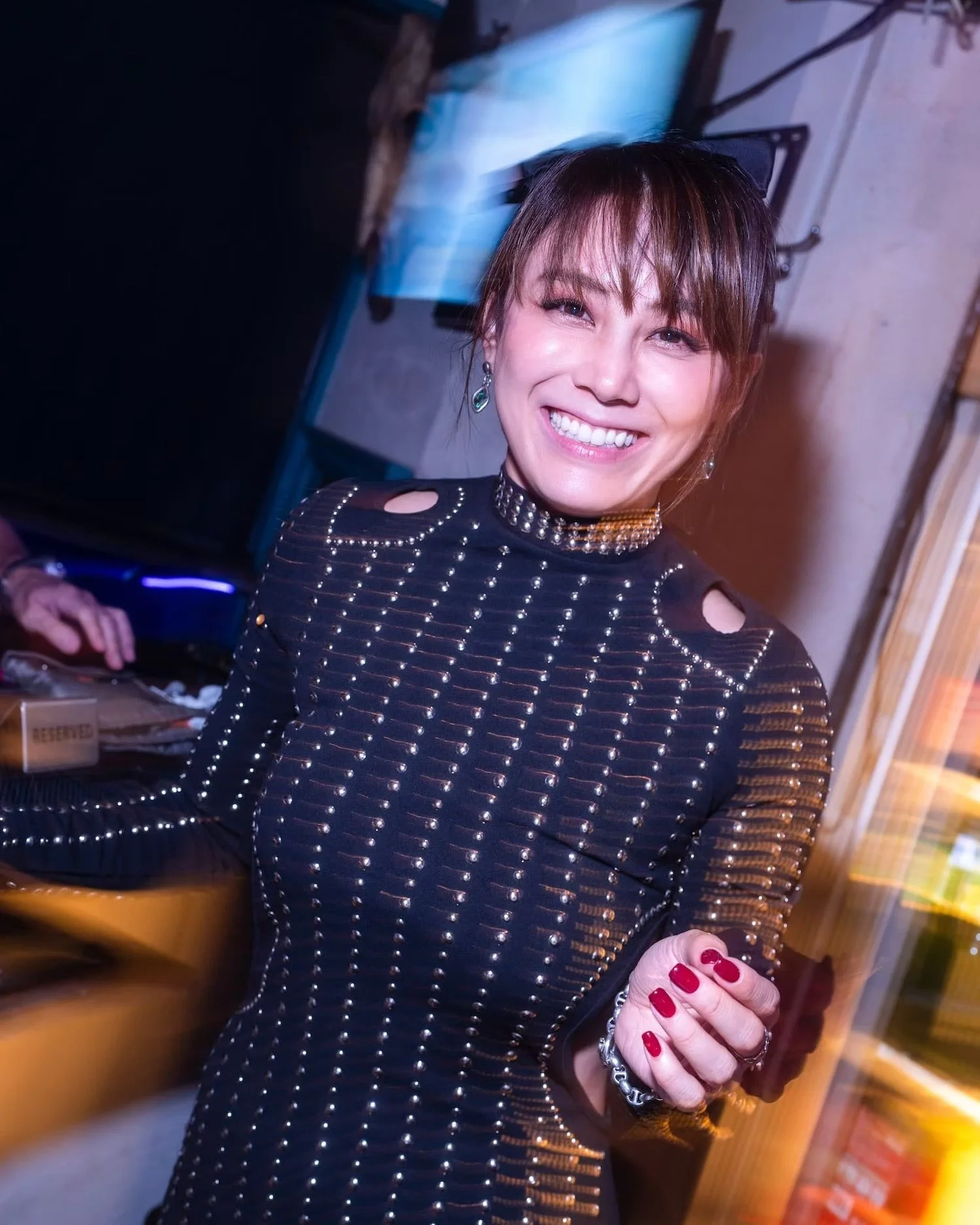 A woman smiling at a lively party in Shibuya: