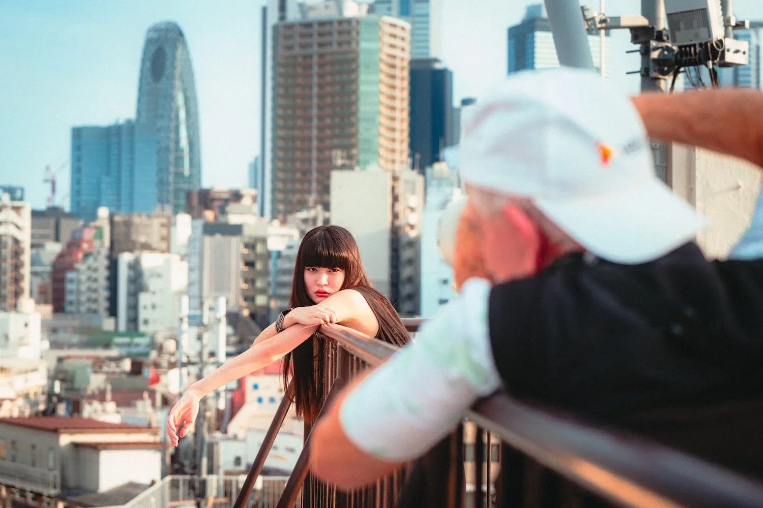 japanese girl on a tokyo rooftop during the day being photographed on a photography workshop led by Deniz Demir