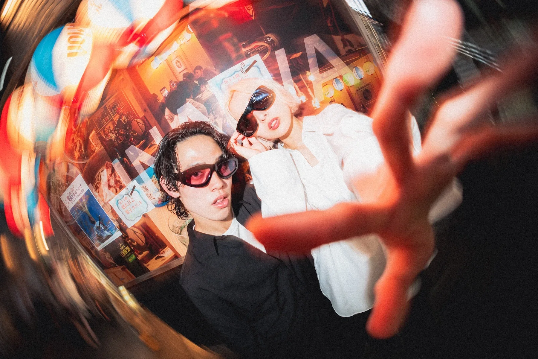Fashionable couple in Tokyo next to an izakaya shot on fish eye wide angle flash by night photographer Deniz Demir