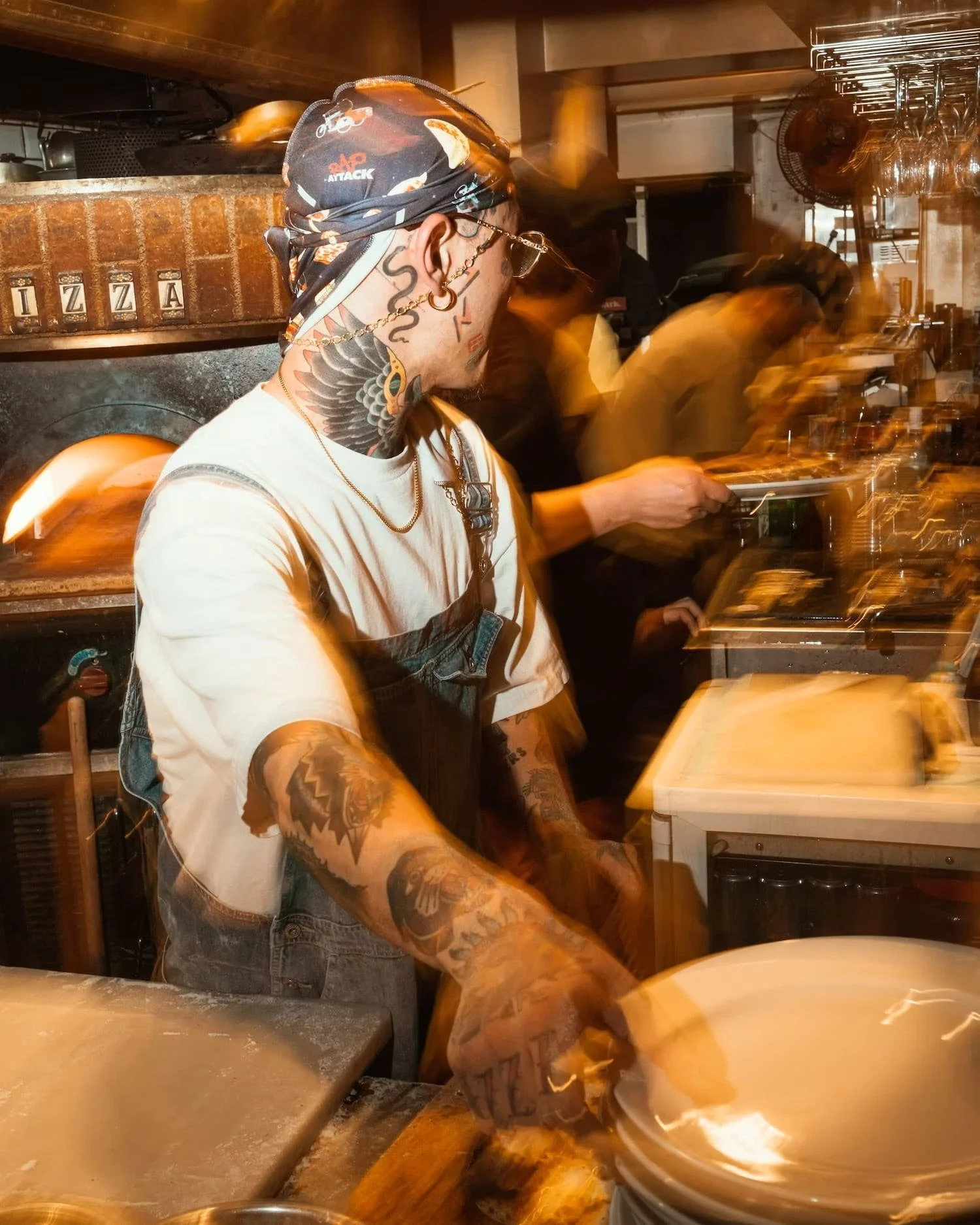 Pizza chef preparing pizza in Shibuya
kitchen at night, Tokyo