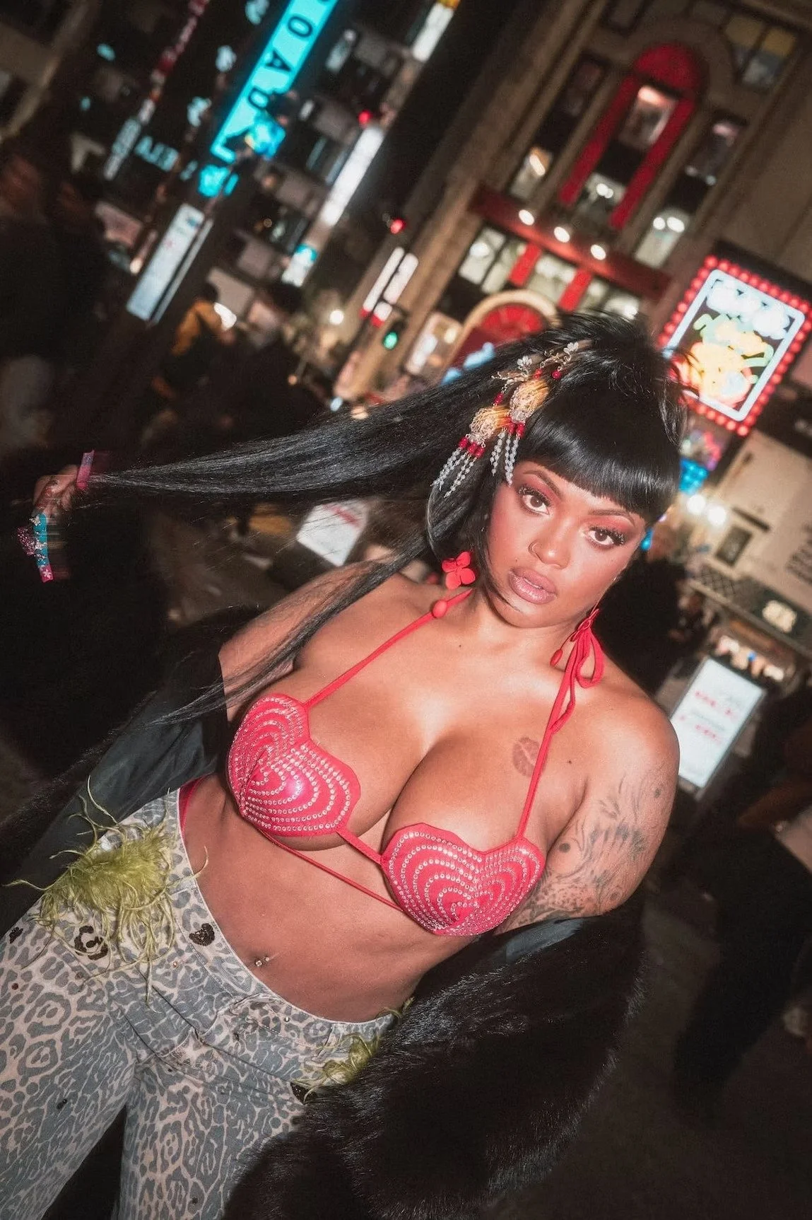 Urban rap hip hop woman posing for flash photographer Deniz Demir in Kabukicho Tokyo
