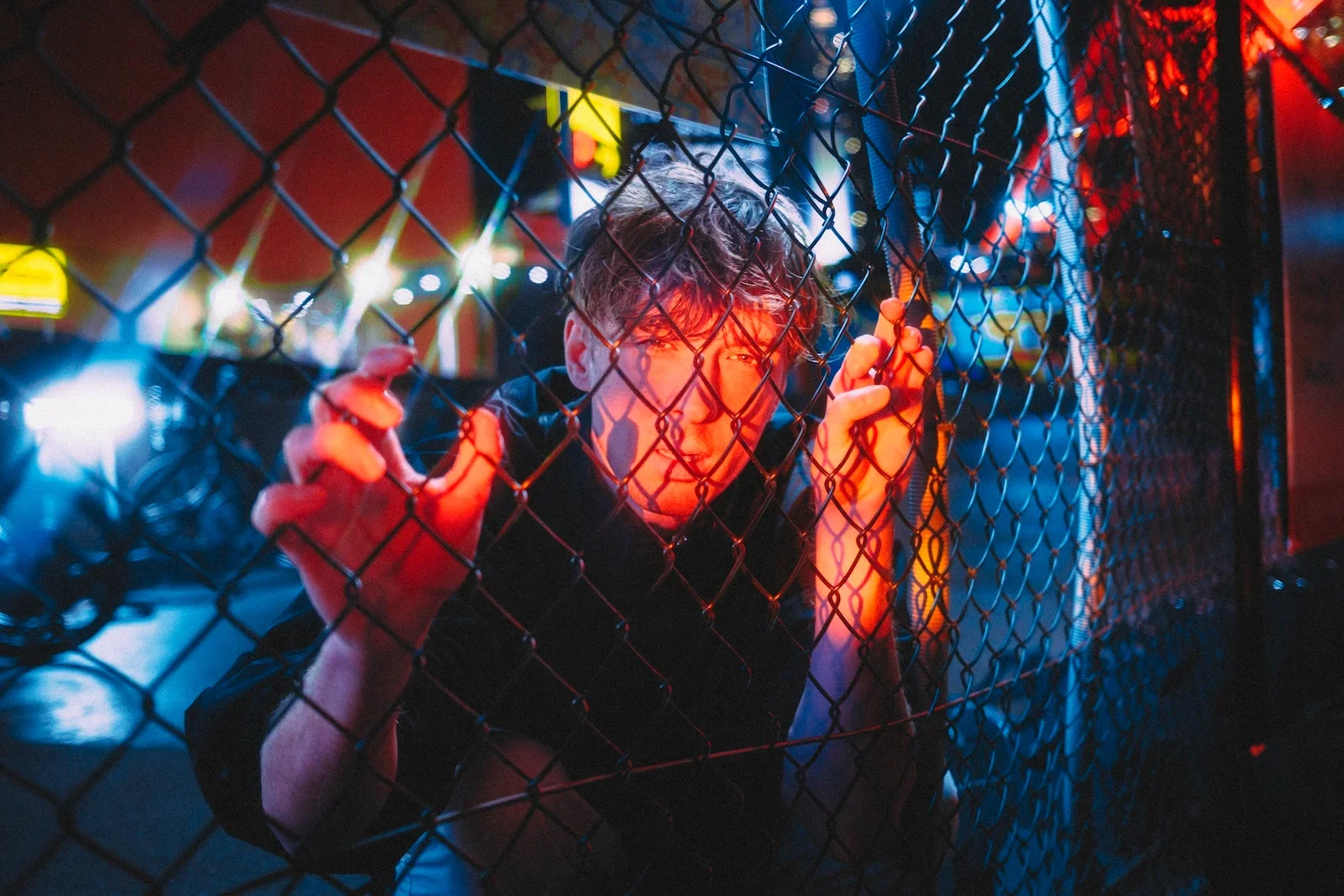 Model staring into the camera with a orange light on him photographed by Tokyo portrait photographer Deniz Demir near Tokyo Tower