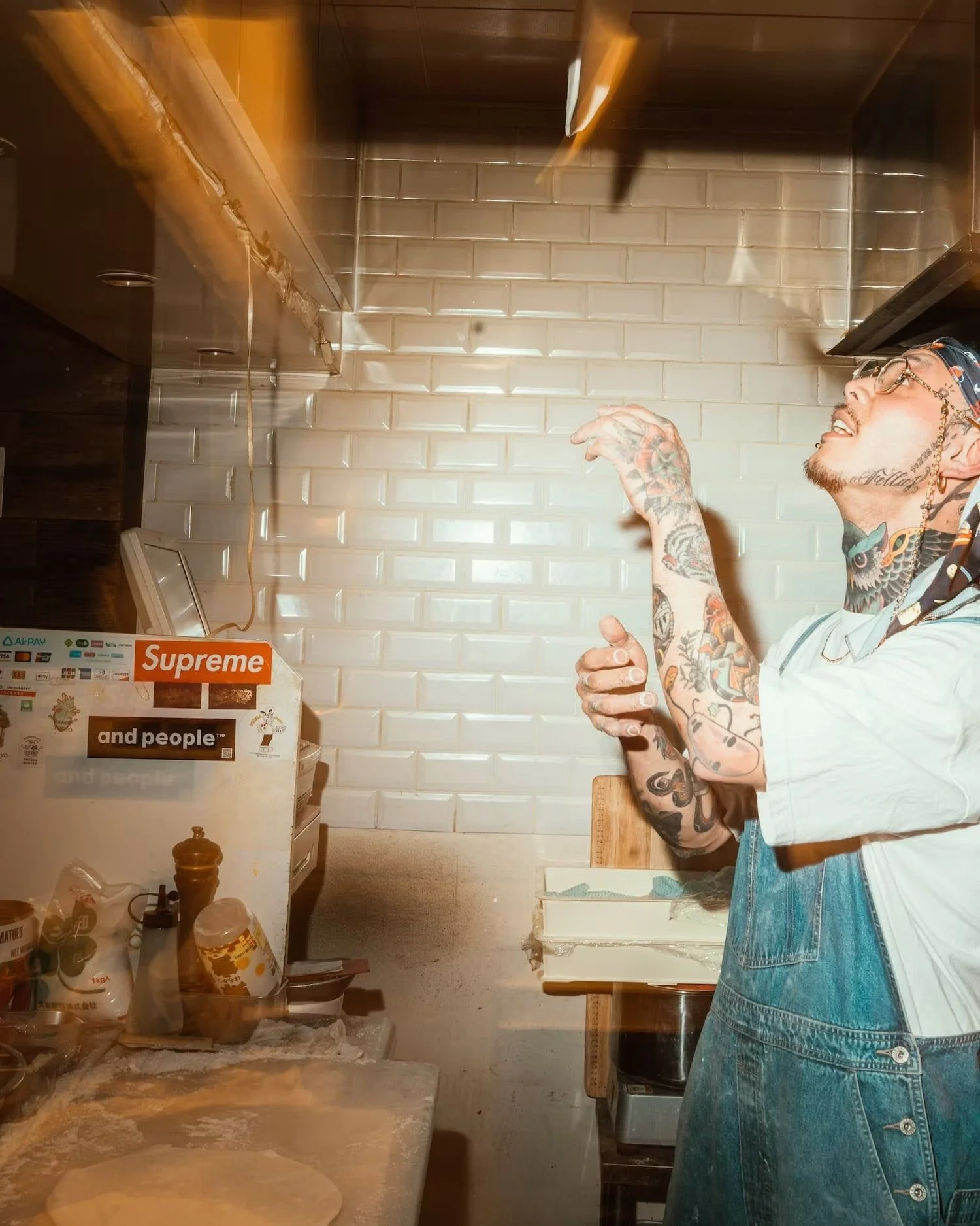 Chef tossing pizza dough in the air
while working in the kitchen