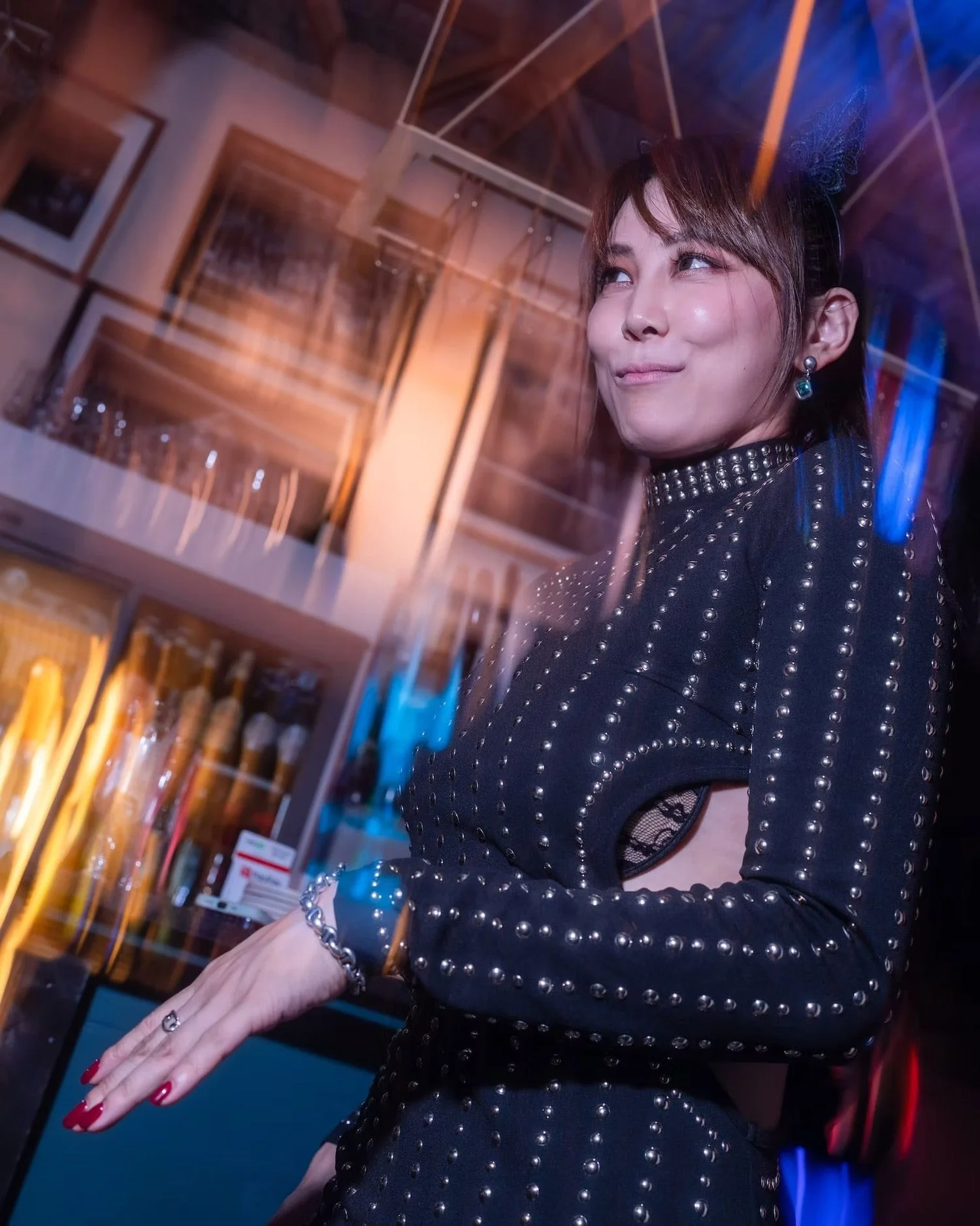 Confident woman striking a pose at a bar in Shibuya.