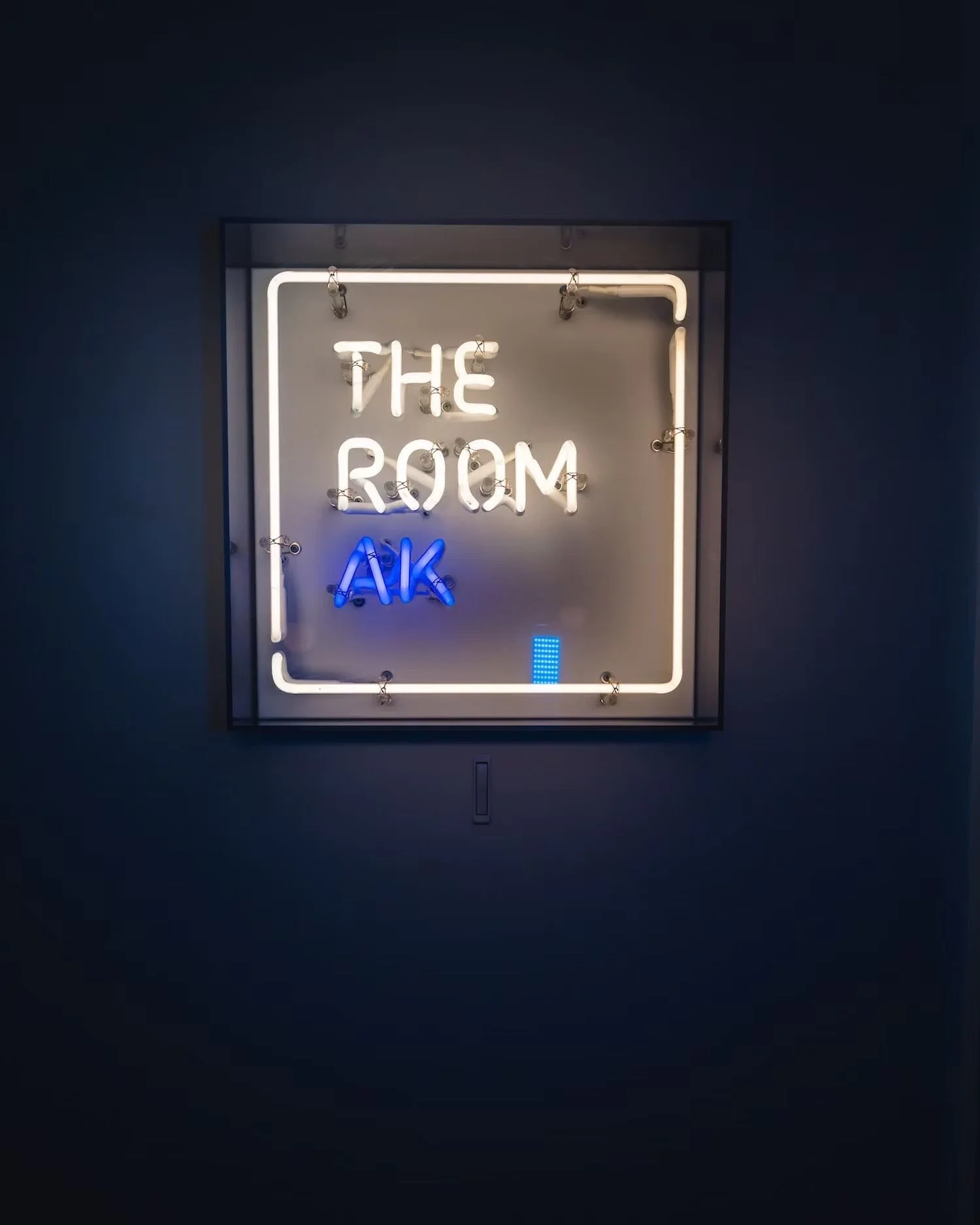 Neon sign of THE ROOM AK