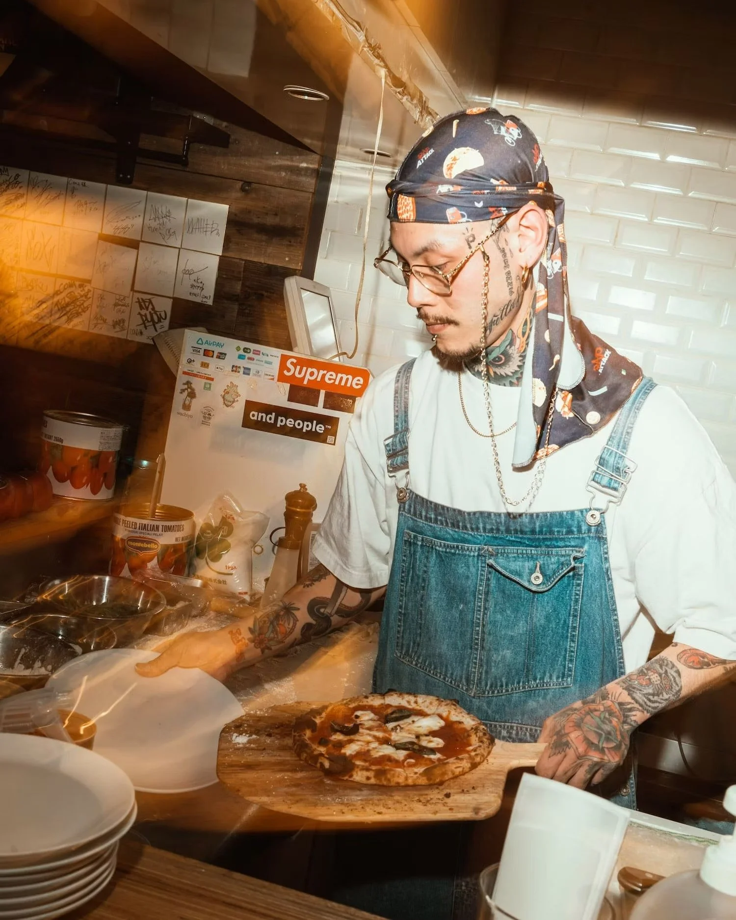 Pizza chef serving pizza in a busy kitchen at a vibrant event in Shibuya