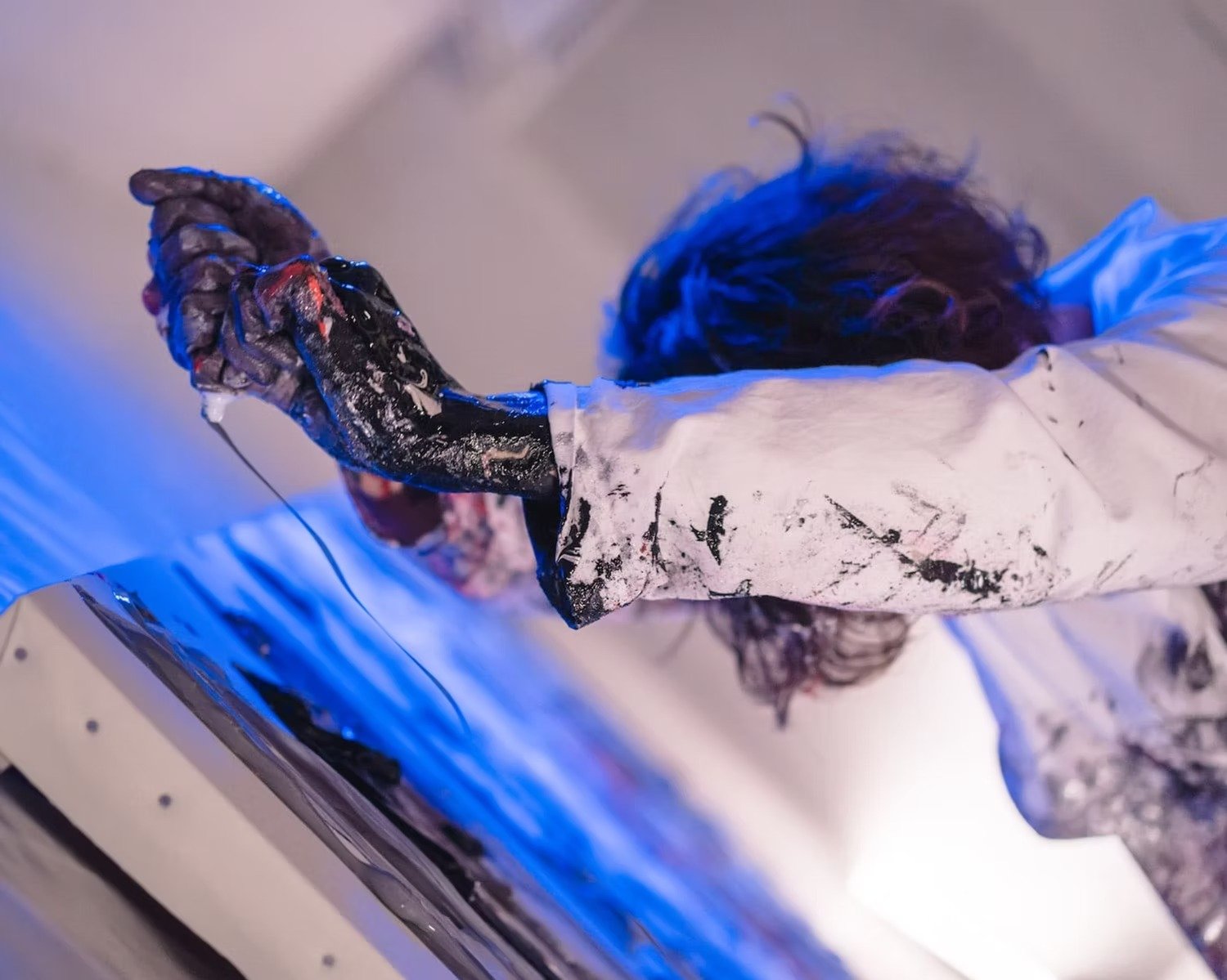 Artist Creating Abstract Artwork in Studio