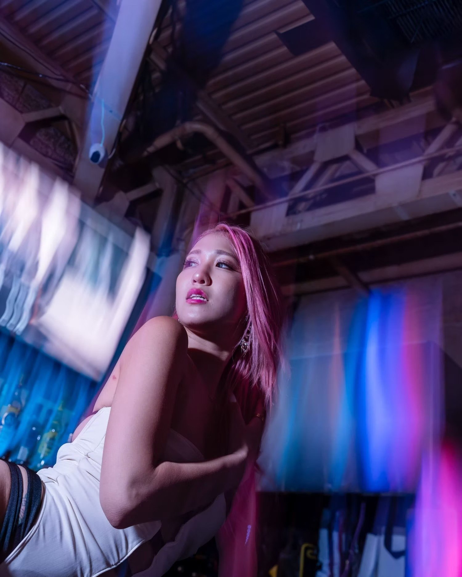 Pink-Haired Woman in a Nightclub with Vibrant Lights