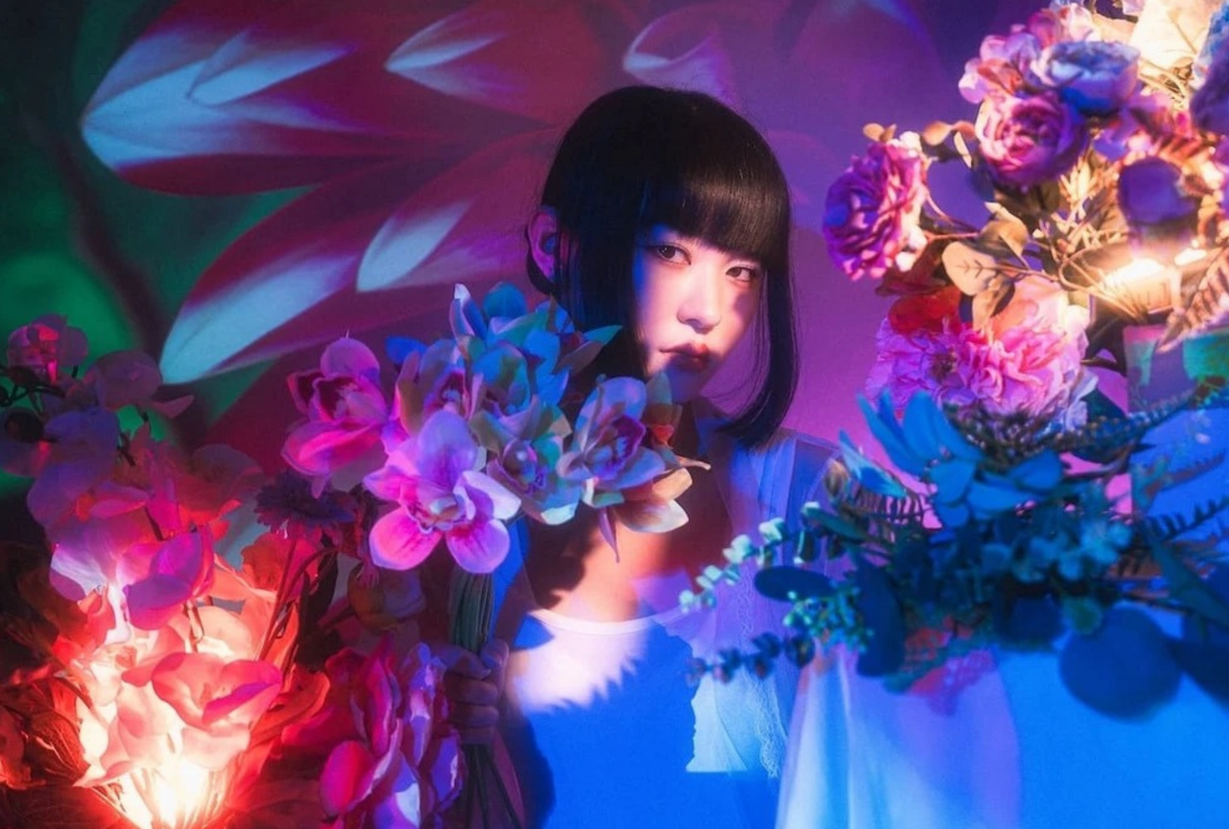 Projector photography with floral arrangements illuminating a model during a studio shoot
