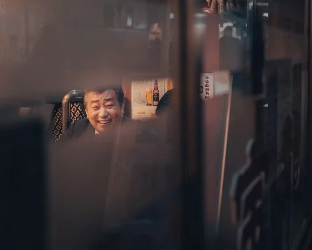 Reflection of Smiling Man in Tokyo Restaurant Window