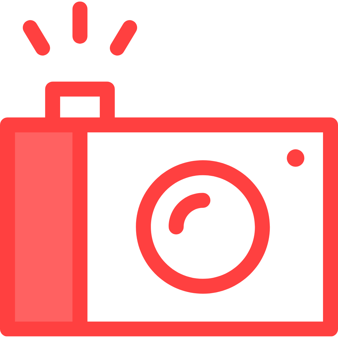 Red emergency siren light on top of a black and red camera.