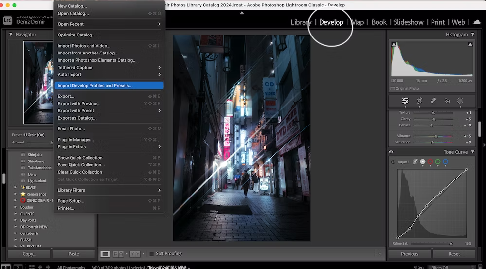 Screenshot of Adobe Lightroom software showing the 'Develop' menu open and an urban night scene photograph in the main editing pane.