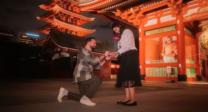 Man proposing to woman wedding engagement in Asakusa Tokyo at night in front of temples