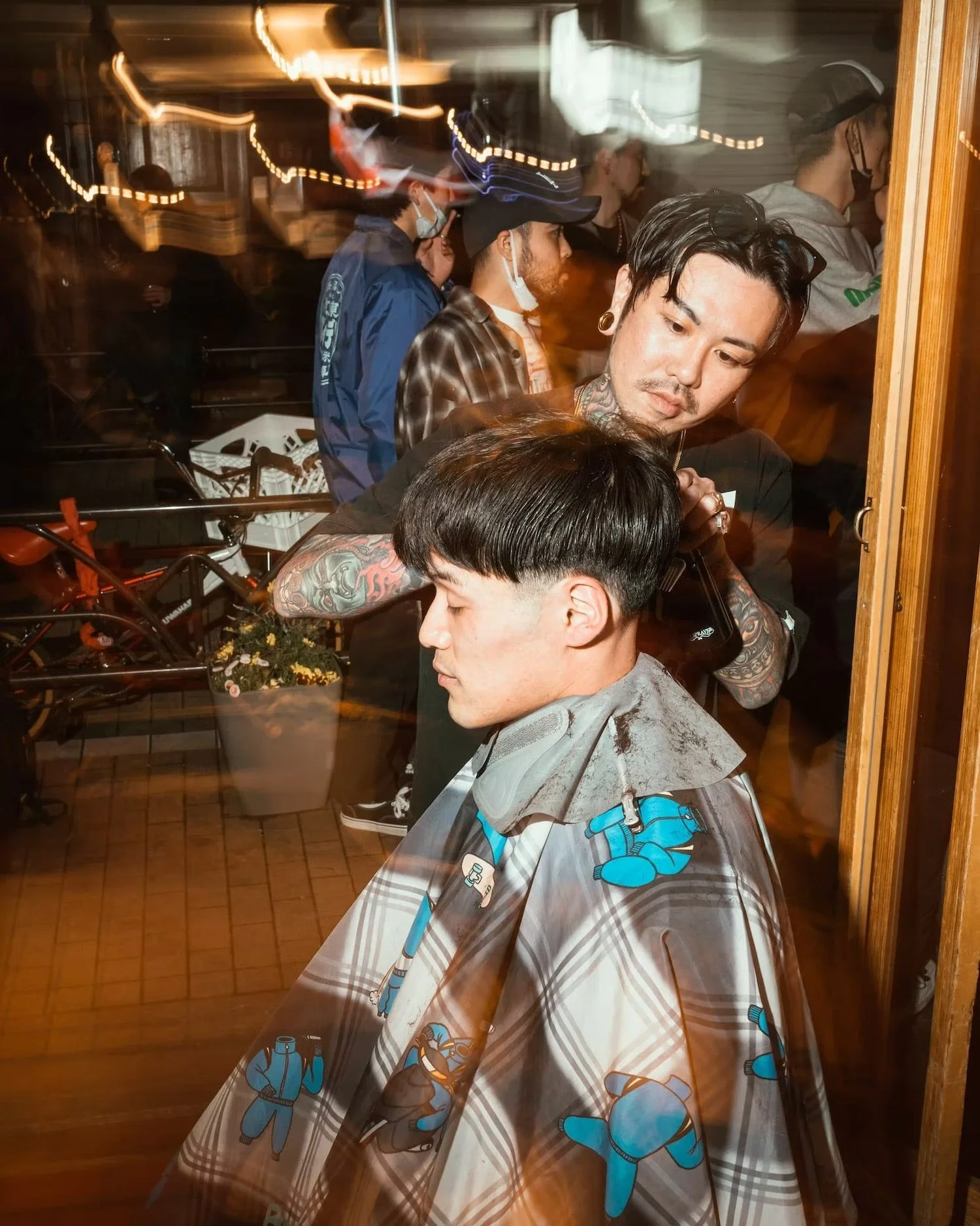 Barber cutting hair at night during event in
Shibuya