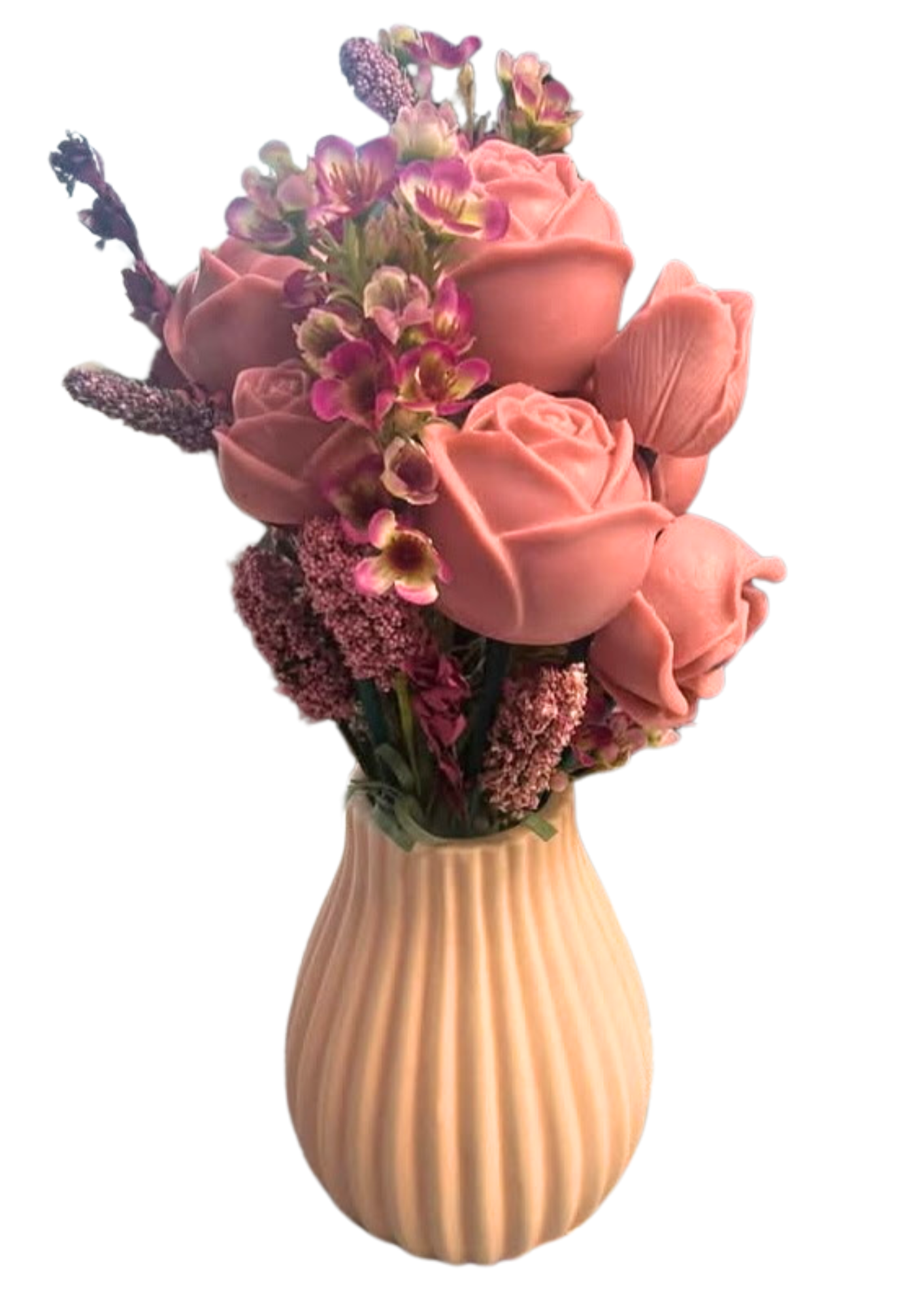 A decorative vase with pink roses, purple flowers, and other small blooms arranged on a ribbed, peach-colored base.