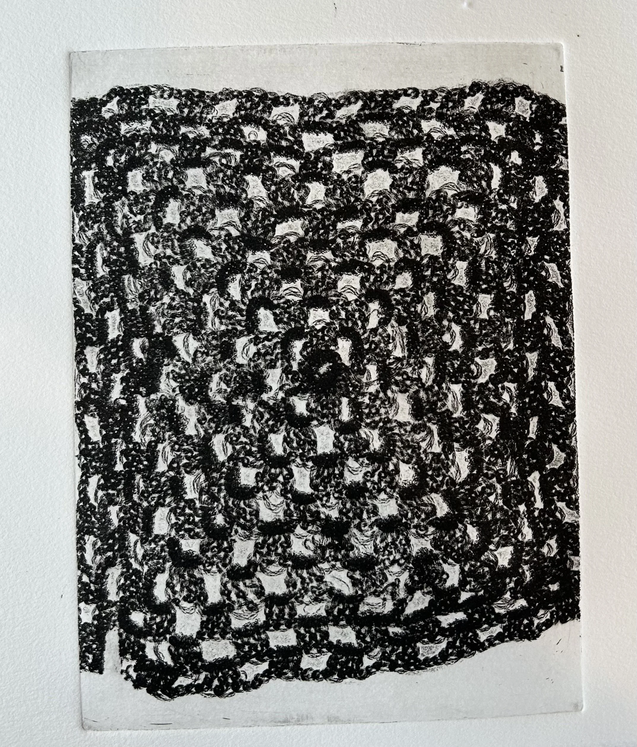 Black and white close-up of a textured woven fabric with intricate patterns.