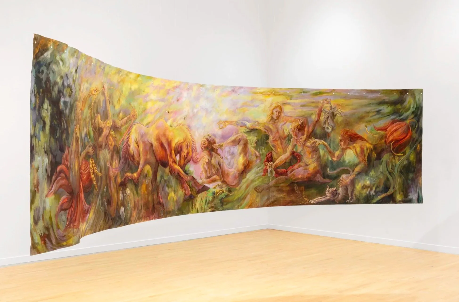 A large, colorful painting displayed on a white gallery wall, depicting a group of mythological or fantasy figures and animals in a swirling, vibrant landscape.