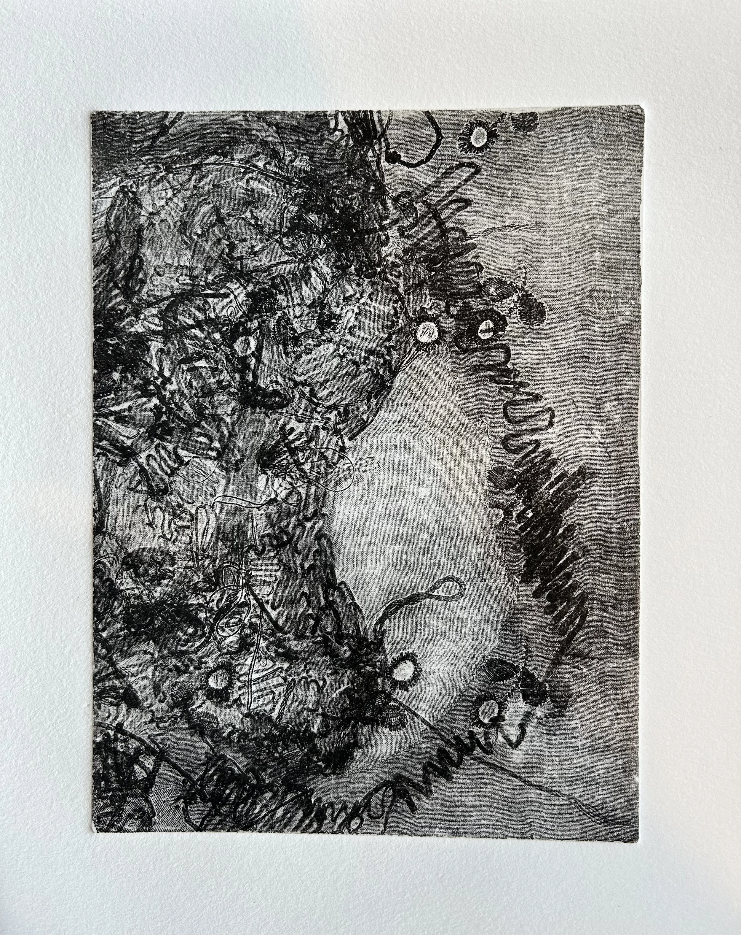 A black and white abstract drawing with tangled lines and scribbles, including what appears to be text and shapes.