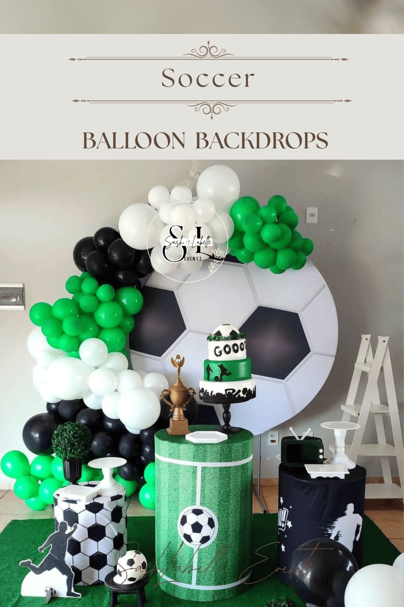 Soccer-themed balloon backdrop with black, white, and green balloons, soccer ball decorations, and soccer figurines. There is a cake with soccer motifs on a green textured table, and related decor items including a gold trophy and a soccer player cut