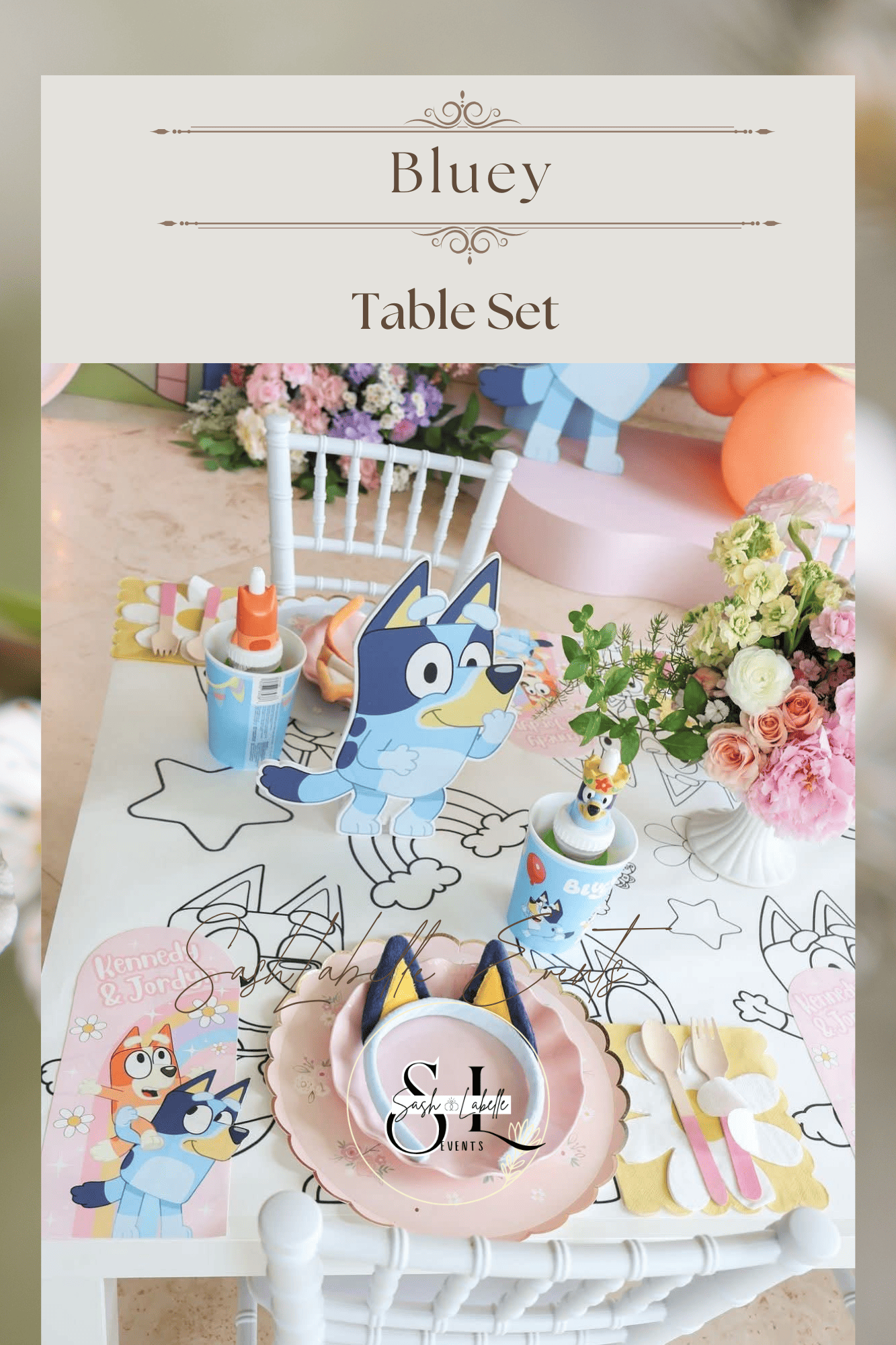 Decorative table setup for a children's party with cartoon dog and cat themed items, flowers, and festive place settings.