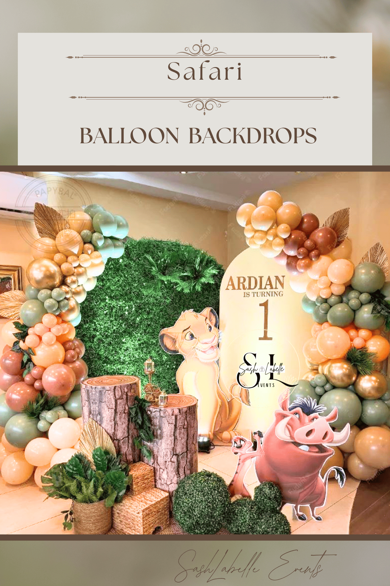 Decorative balloon backdrop with a jungle theme featuring cartoon animals like a lion, pig, and warthog, with greenery and tree stump props, for a child's birthday party.